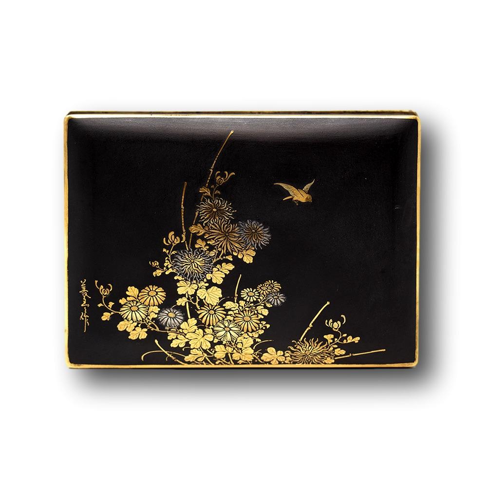 A fine Japanese Meiji period box in the Komai style. The box of rectangular shape with hinged lid worked beautifully with gold and silver nunomezogan on a matt black ground. The lid decorated with blossoming Chrysanthemums with various gauge wire