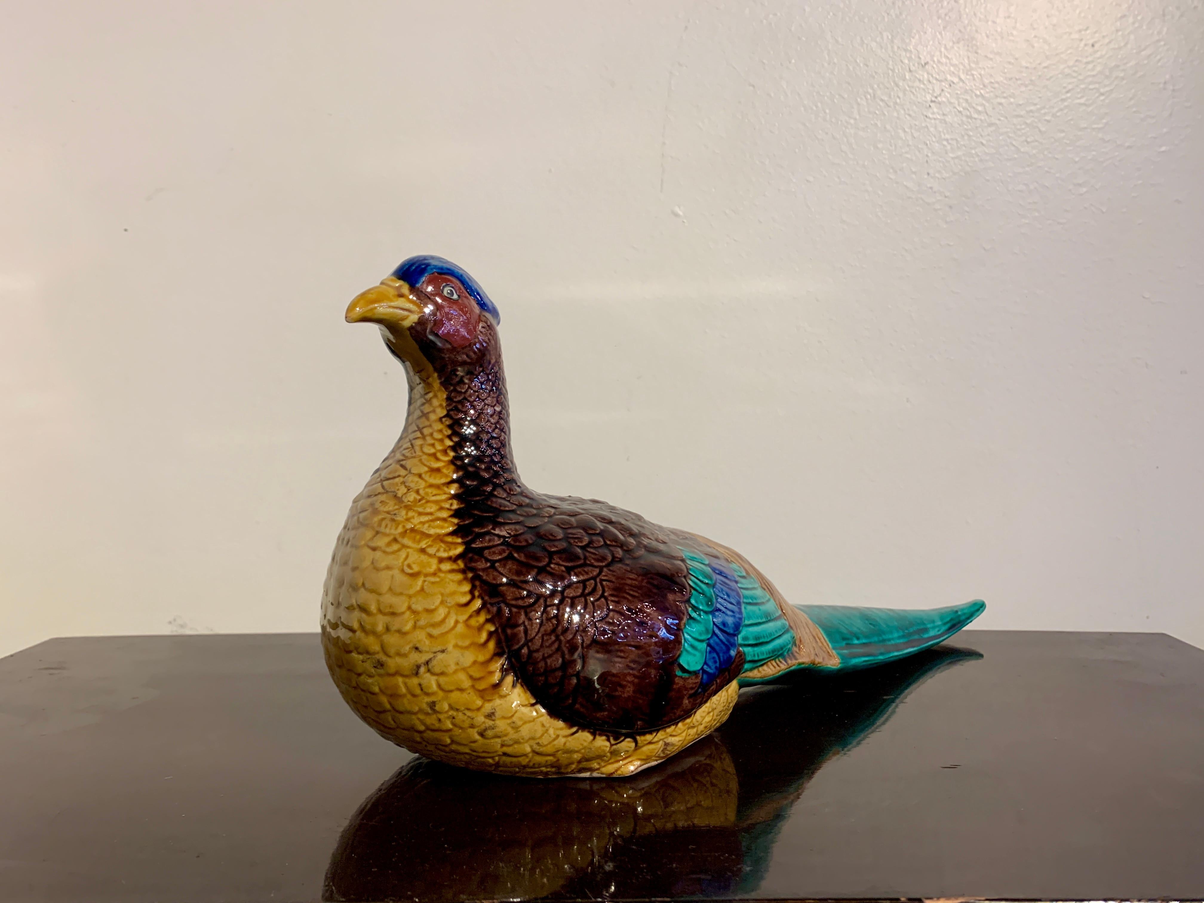 A spectacularly glazed Japanese Kutani model, okimono, of a pheasant, Showa era, early 20th century, Japan.

The okimono, or decorative sculpture, in the form of a magnificent pheasant portrayed in a recumbent position, head up and alert, wings