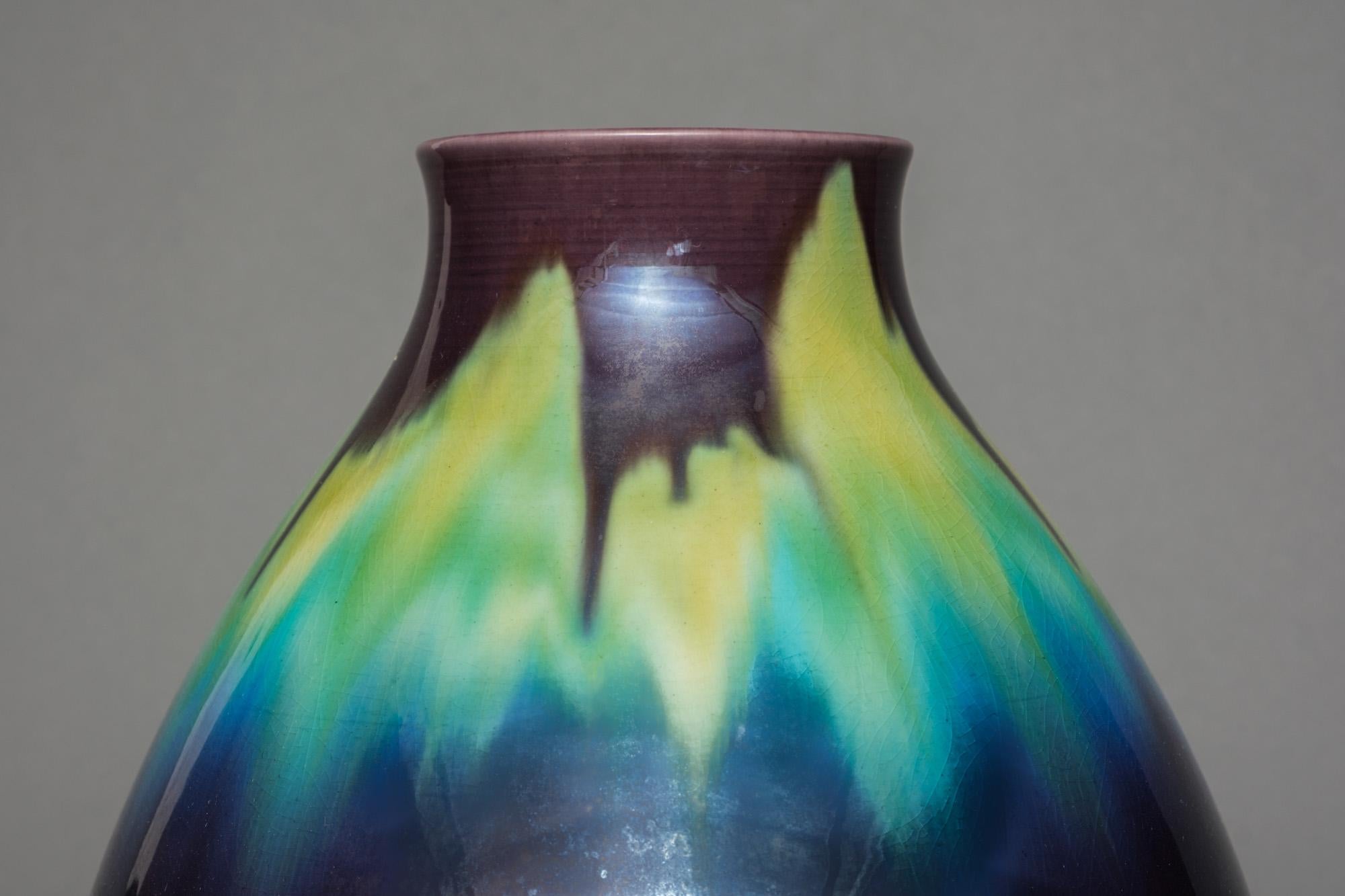 Exquisite Kutani-ware porcelain vase of bluster shape by the famous artist Tokuda Yasokichi III (Masahiko) (1933-2009). Its body decorated with his iconic ‘saiyu’ glaze in transcending shades of black, azure blue, lime green and aubergine purple.