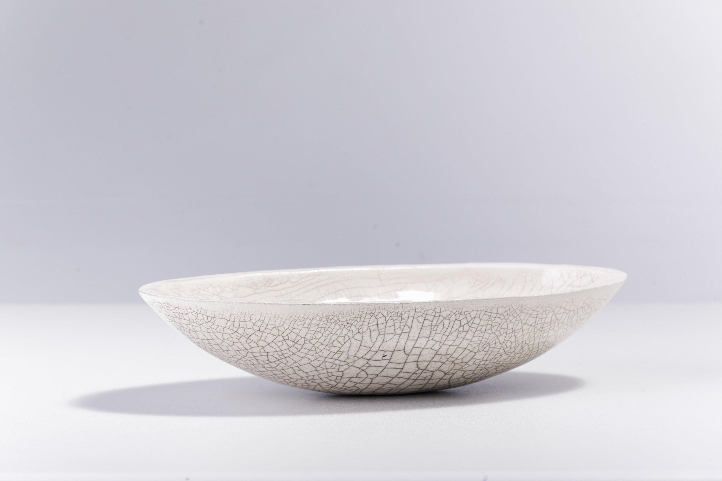 Donburi L bowl

Exuding a sublime and strong visual impact in its singular design handcrafted following the Japanese raku pottery technique, this oval bowl is named after the internationally renowned and appreciated Korean dish. A unique,