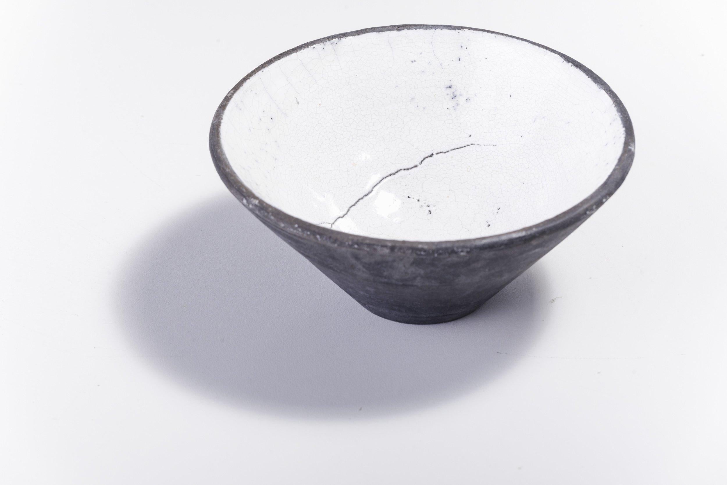 Wu bowl

Distinguished by an alluring raw character, this gorgeous ceramic bowl is deftly handcrafted following the Japanese Raku technique that creates unique objects naturally decorated. This piece features a conical shape distinguished by an