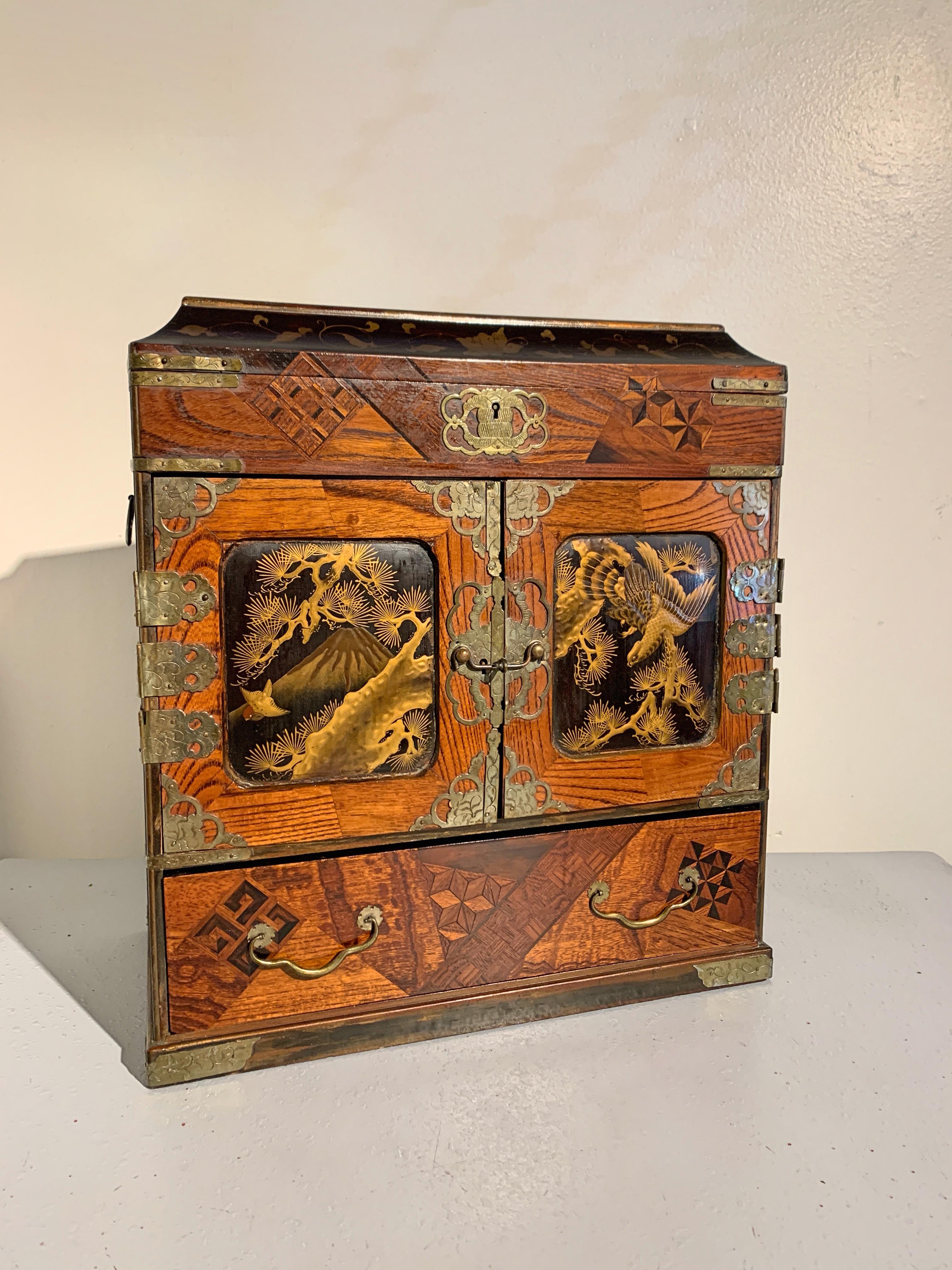 A beautiful Japanese wood table top jewelry or collector's chest with marquetry and lacquer decoration, Meiji period, late 19th century, Japan.

The chest is crafted in the form of a Chinese seal chest, a mainstay of the scholar's studio. The