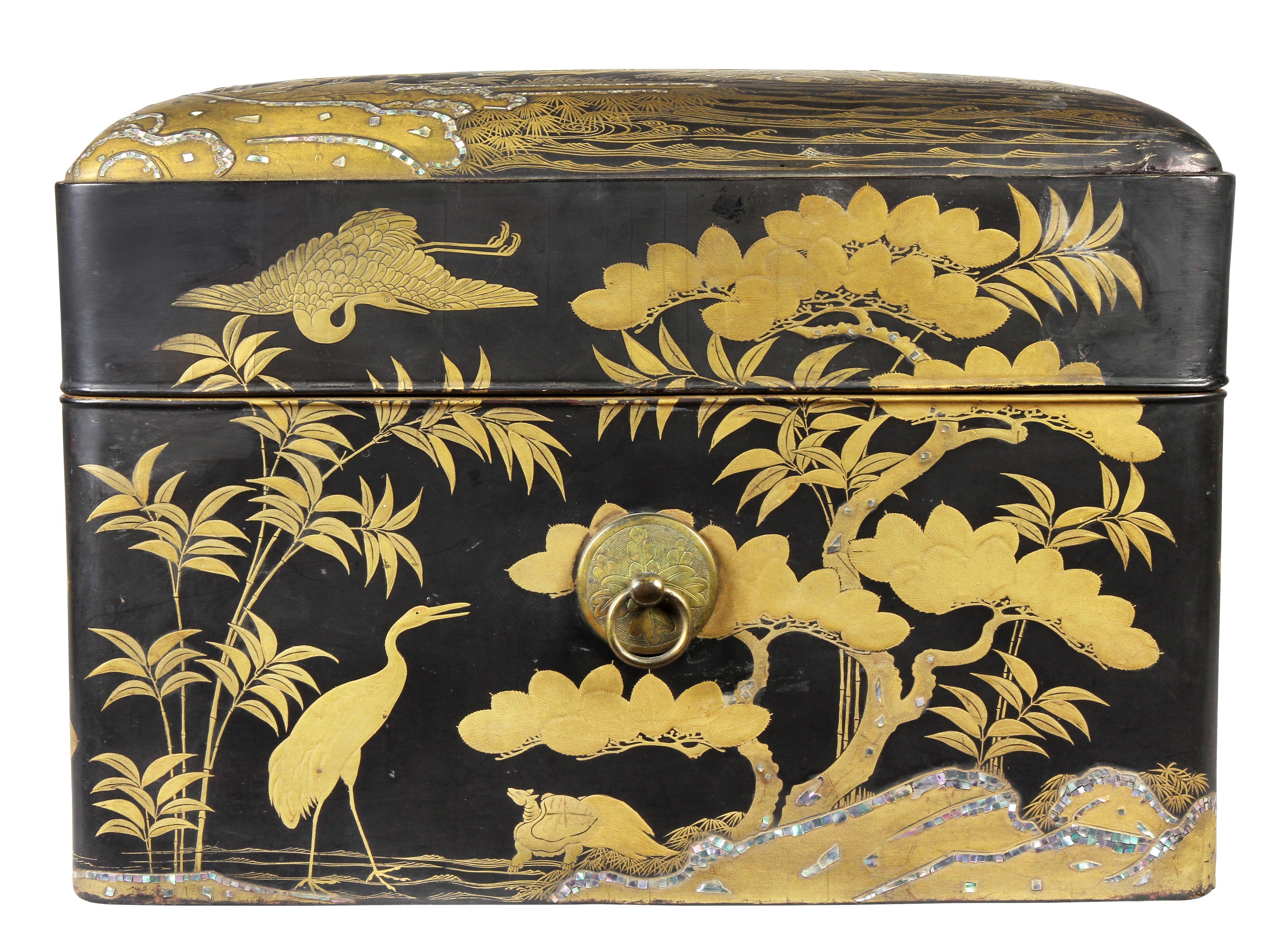 Decorated overall with gilt and mother of pearl decoration on a black ground with cranes and trees.
