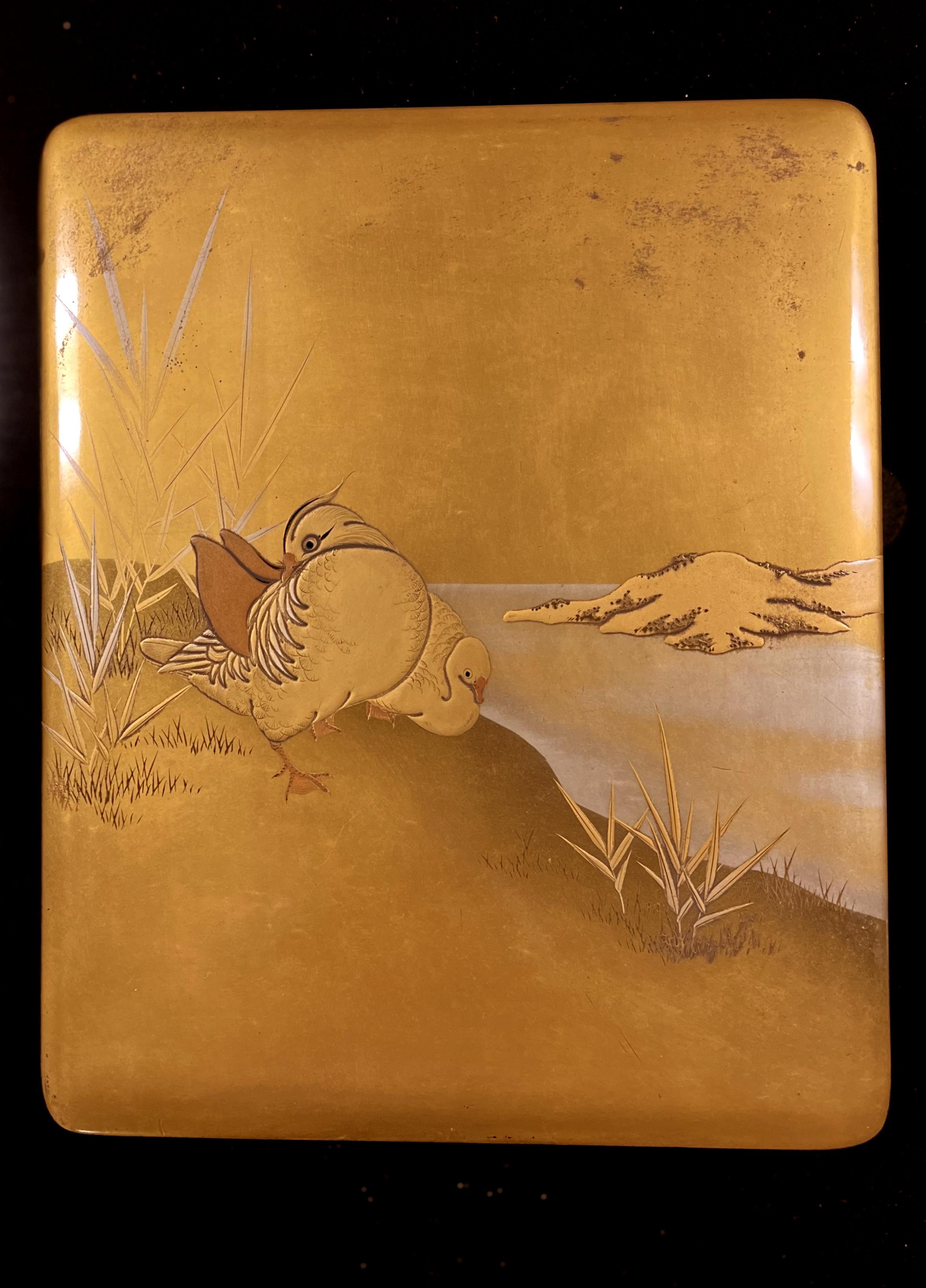Japanese lacquer box with mandarin ducks motif on cover. One lacquer tray and one small lacquer plank inside the box.
 