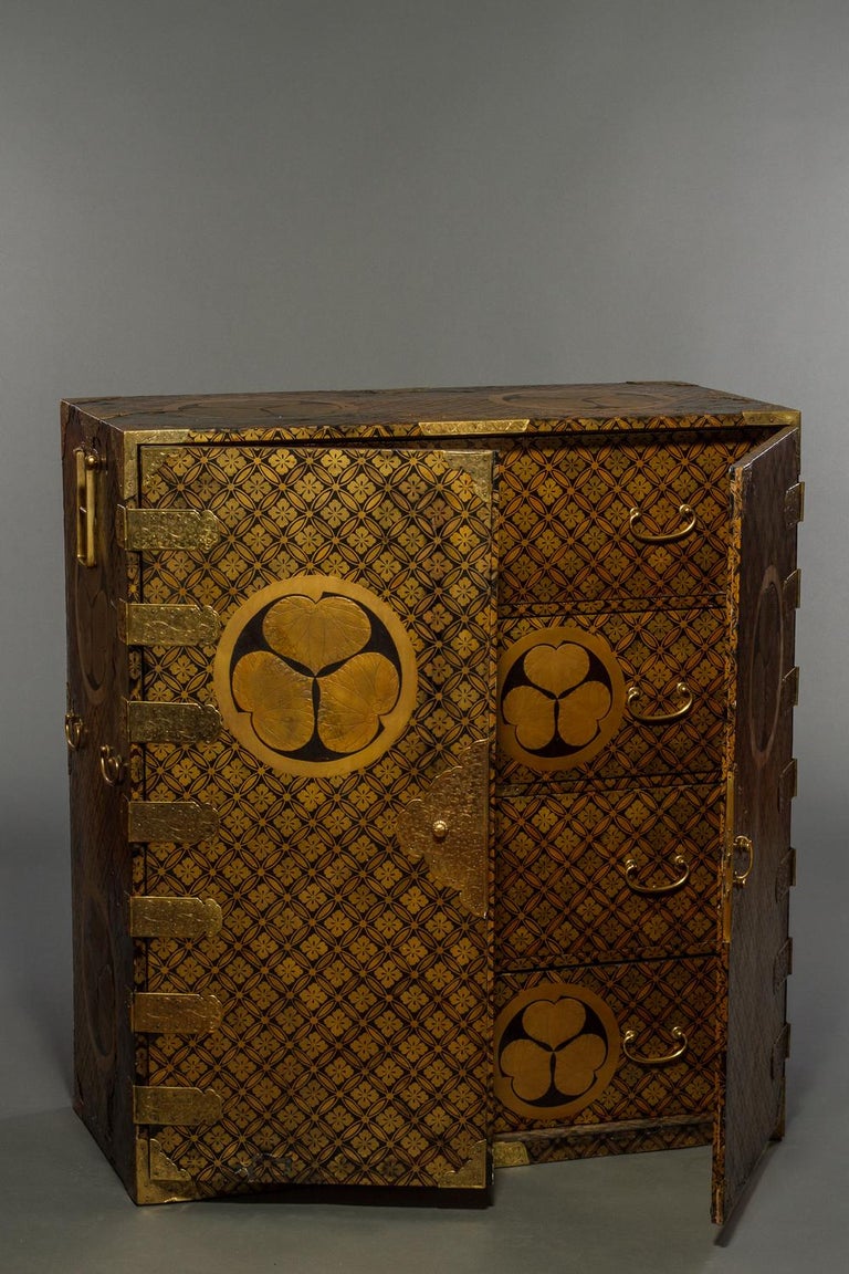 With gold mons (family crests) of the Tokugawa family and all over design, gilded bronze hardware and four drawers. The Tokugawa family ruled from the 17th to the 19th century. Most likely, this cabinet did not belong to the Tokugawa family, but to