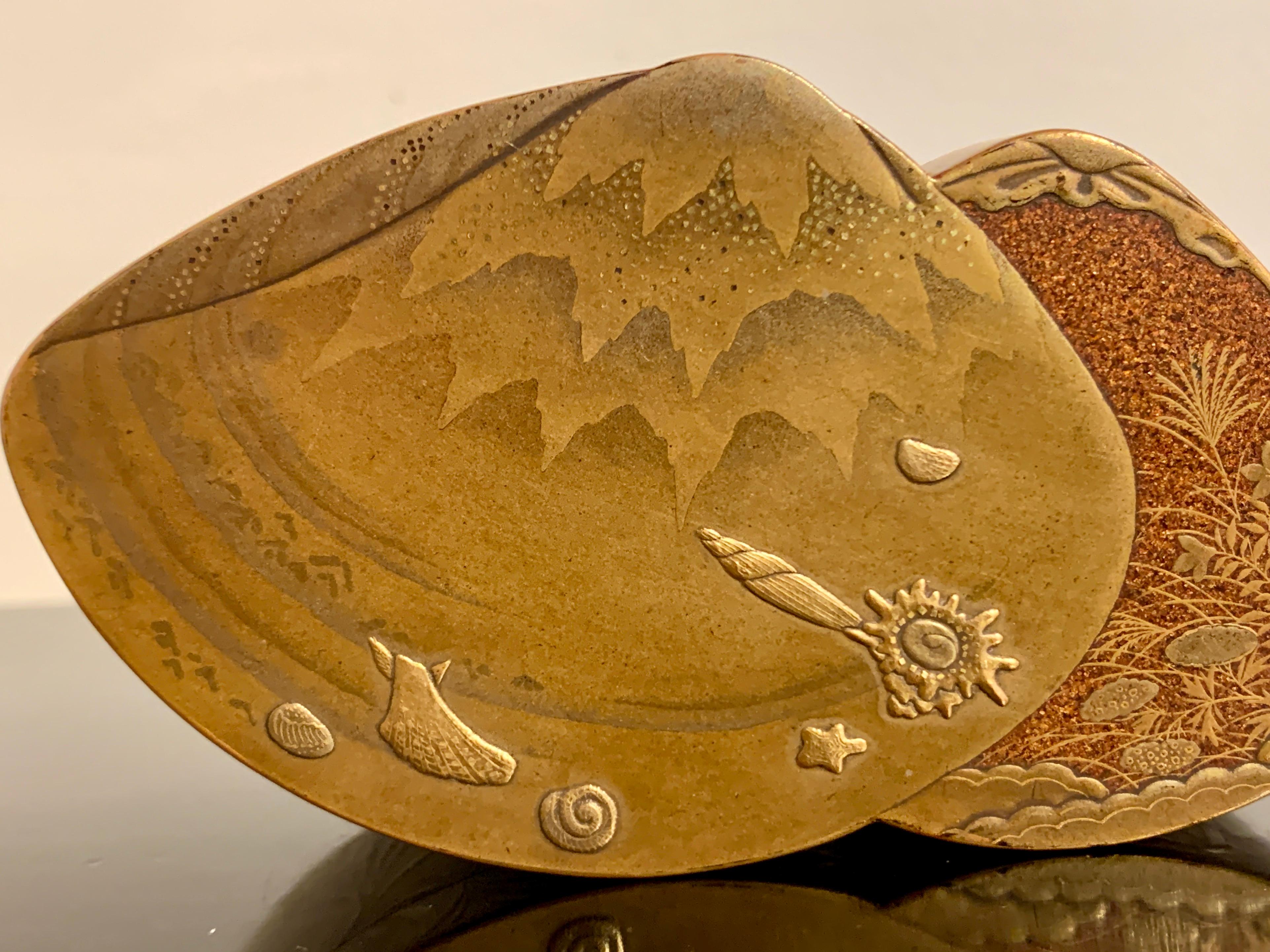 A very fine Japanese lacquer kogo, box for incense, in the shape of two clams, by Zohiko, Meiji period, late 19th or early 20th century, Japan.

The exquisite small Japanese lacquer box, known as a kogo, was originally used to store precious