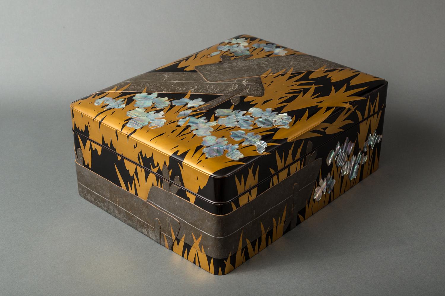 Gold and shell inlay marsh irises with pewter walkway wrapping around box, a Korin style subject matter. Nashiji ground interior and bottom with artist signature inside the lid, reads: Iwayama.
Comes in original storage box, (calligraphy on box
