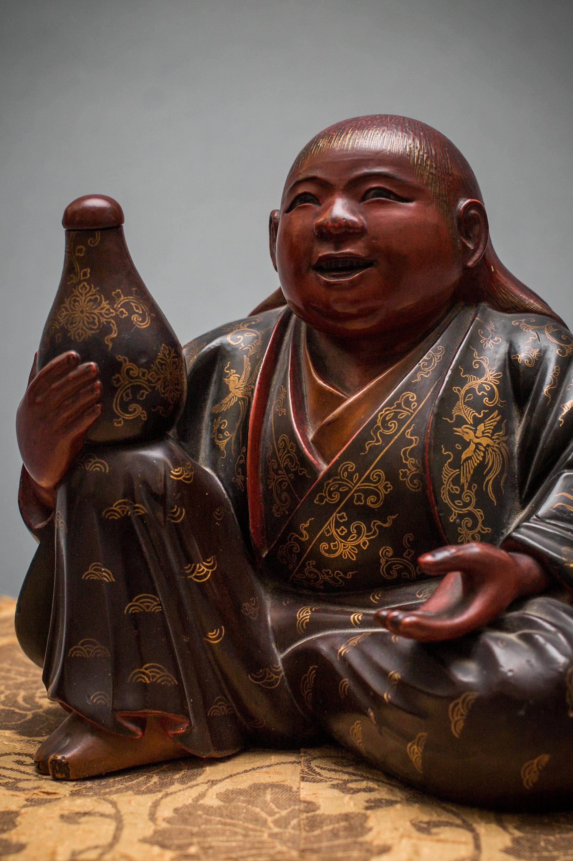 In the shape of a red-faced shijo holding his own tokkuri.
