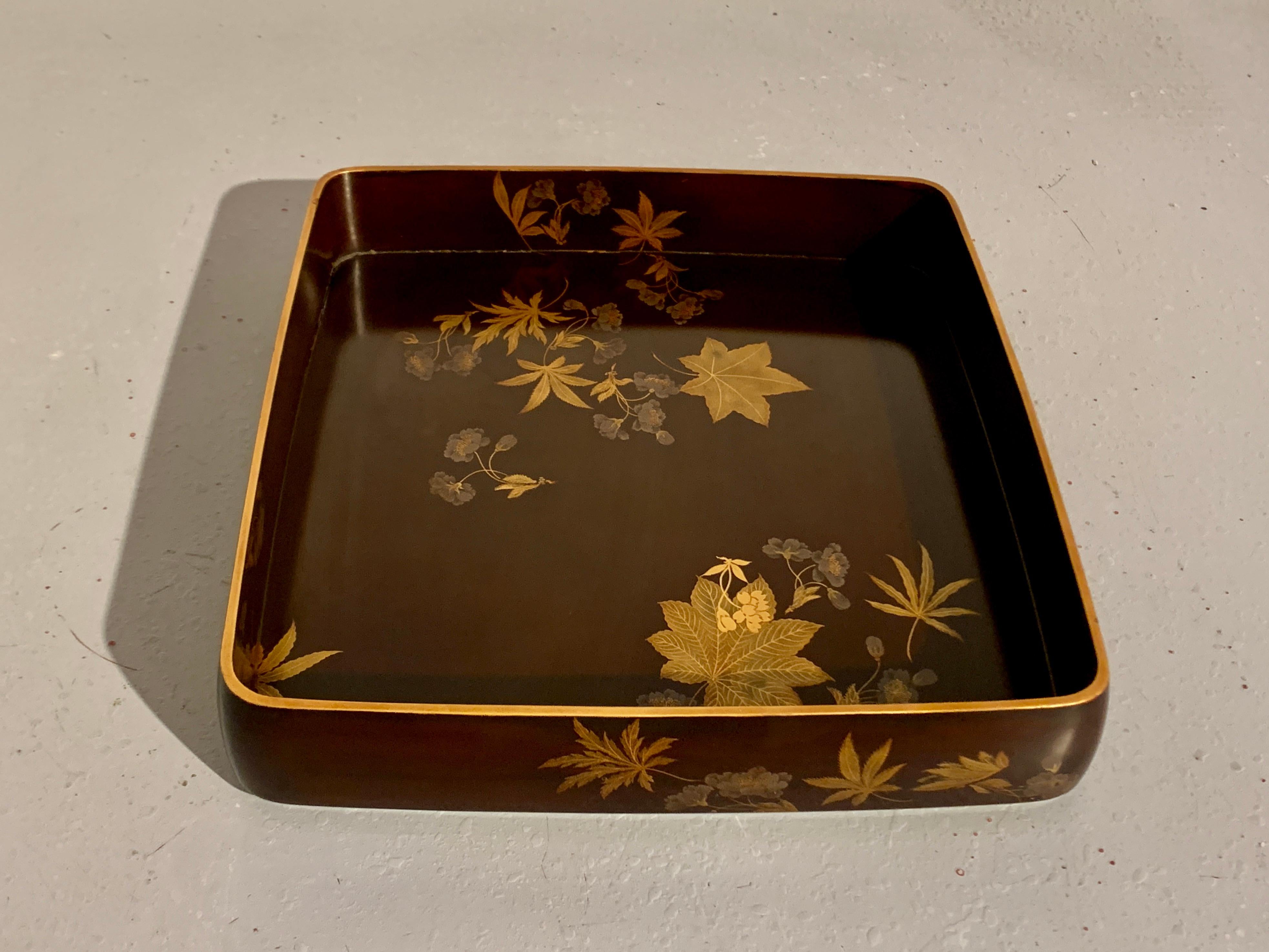 A lovely Japanese lacquer decorated tray with images of hemp leaves, maple leaves, and cherry blossoms by Zohiko, Meiji or Taisho Period, early 20th century, Japan.

The graceful tray expertly crafted with rounded corners and edges. Decorated in