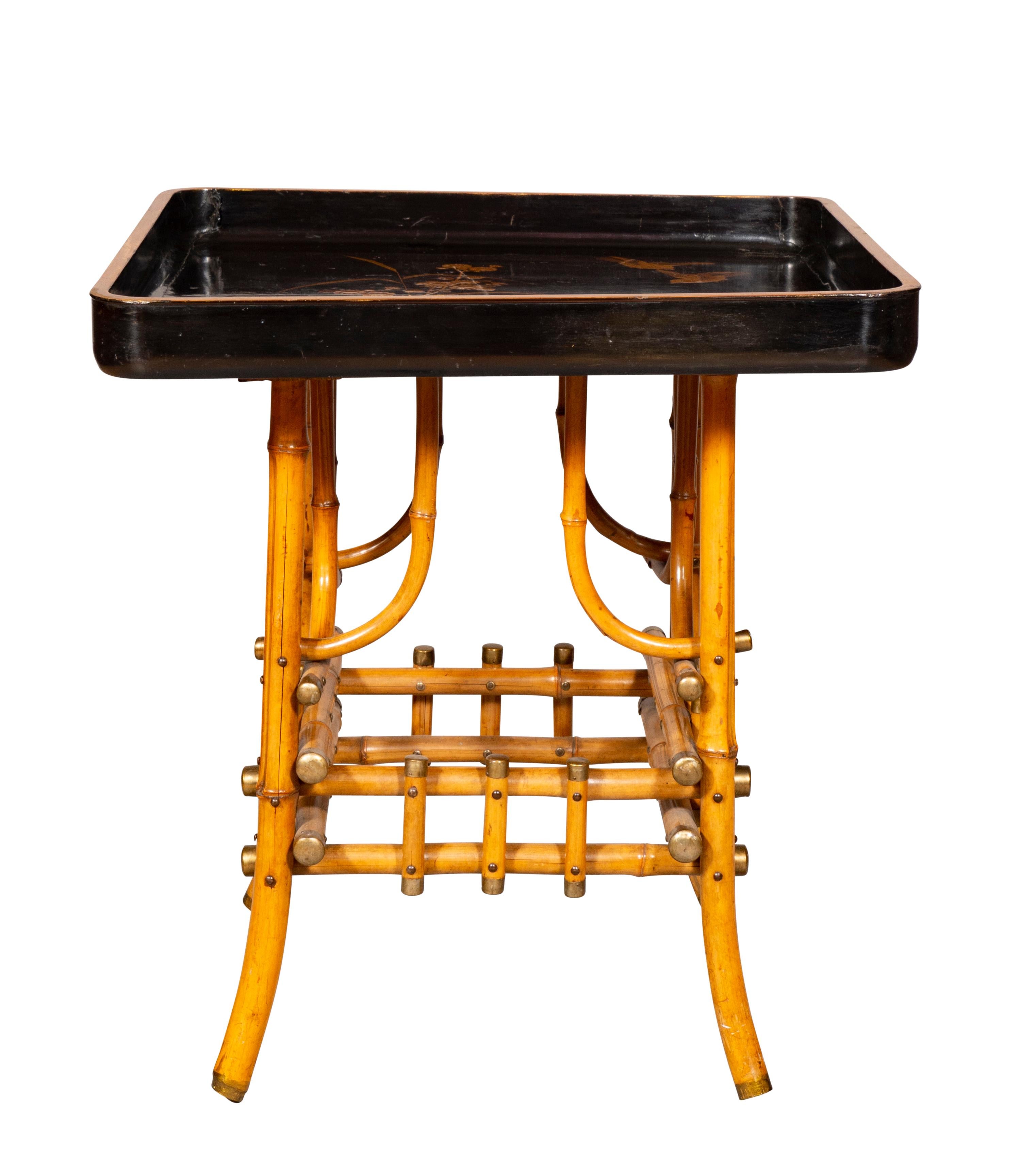 Square black lacquer tray with gold decoration on a bamboo base. From William Hodgins Inc.