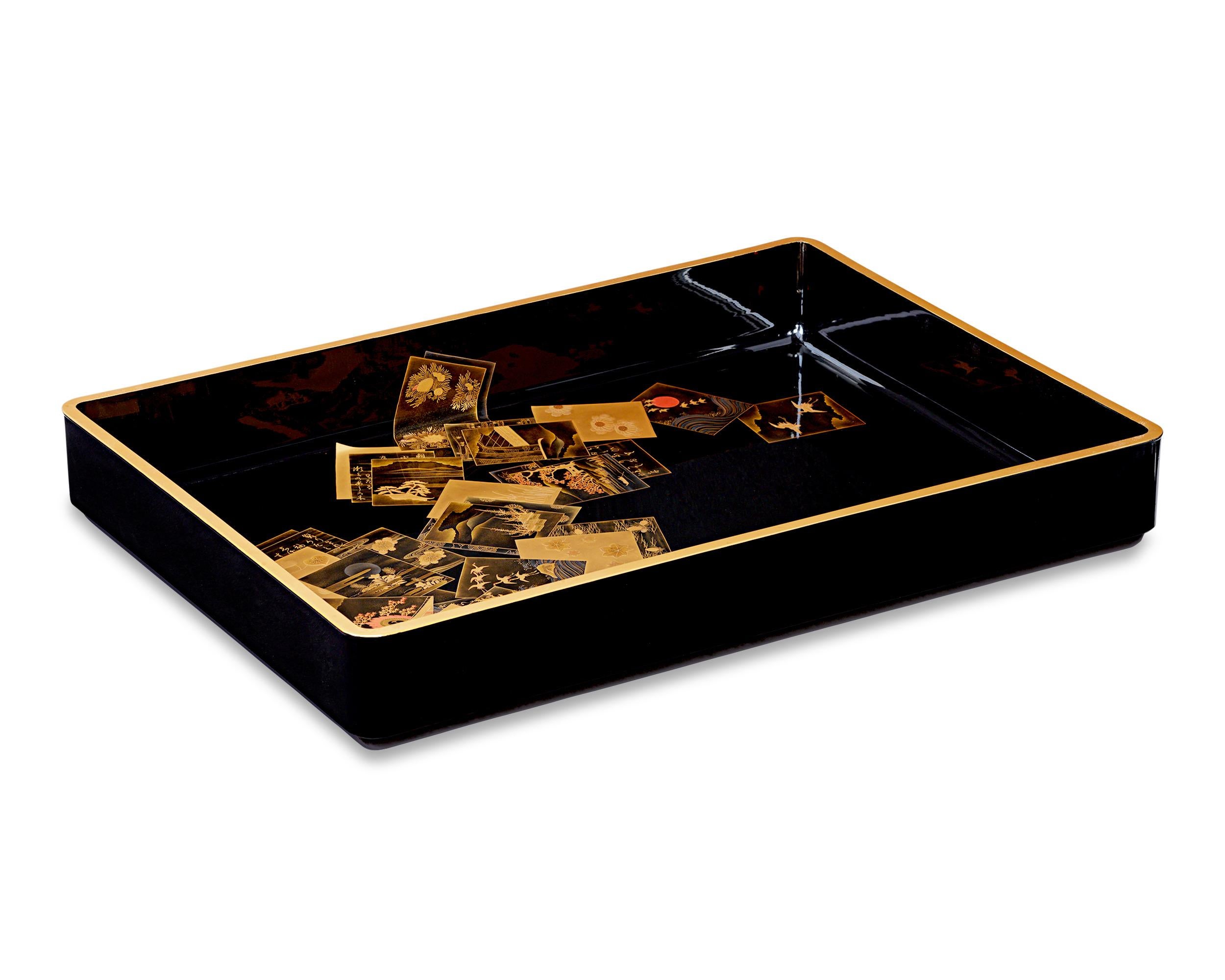 This Meiji-period lacquer tray represents the mastery of Japanese craftsmen in the art of lacquer work. Precious materials are precisely inlaid in the lacquer base, creating a highly illusionistic three-dimensional effect. Gold lacquer borders the