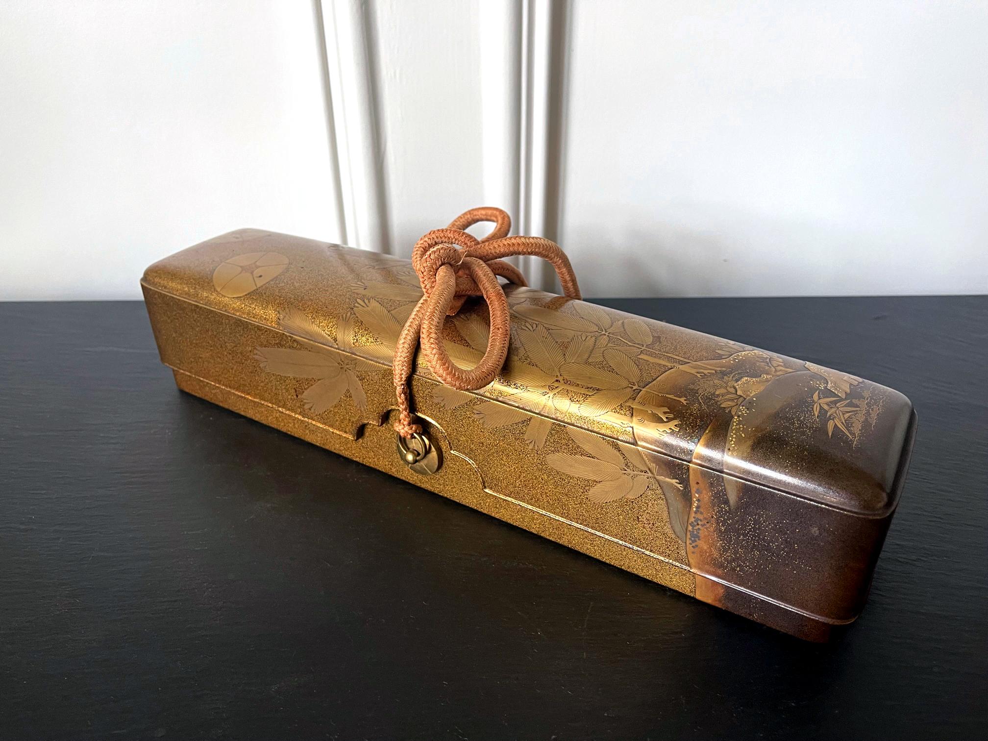 A Japanese lacquered wood Naga Fubako (a long box used to store document or large scroll painting), circa 19th century Meiji period. The rectangular box features an unusually deep lipped lid with slightly rounded corners, a conforming lower box with