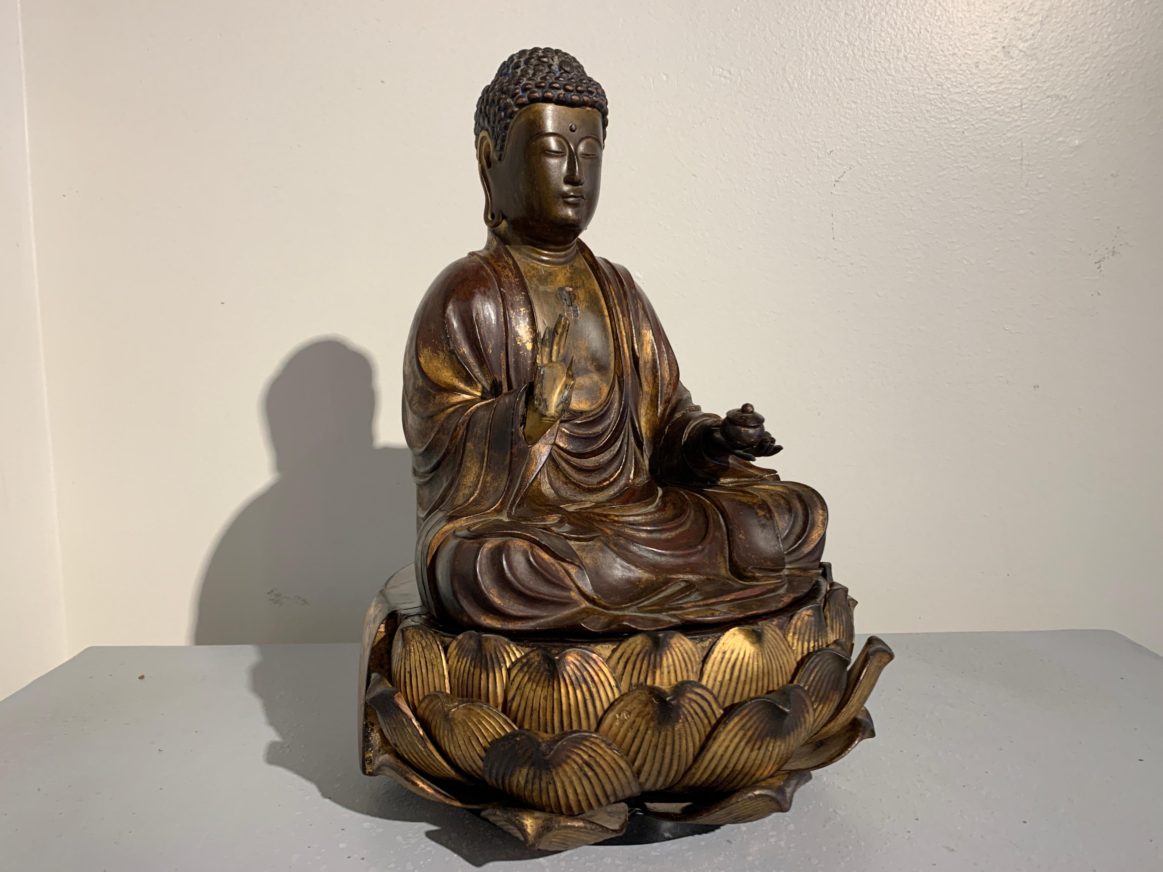 A fine and beautiful Japanese carved and lacquered Medicine Buddha, Yakushi Nyorai, Edo Period, early 18th century.

The Medicine Buddha, Bhaisajyaguru, known as Yakushi Nyorai in Japan, is portrayed seated upon a large lotus pedestal. The Buddha