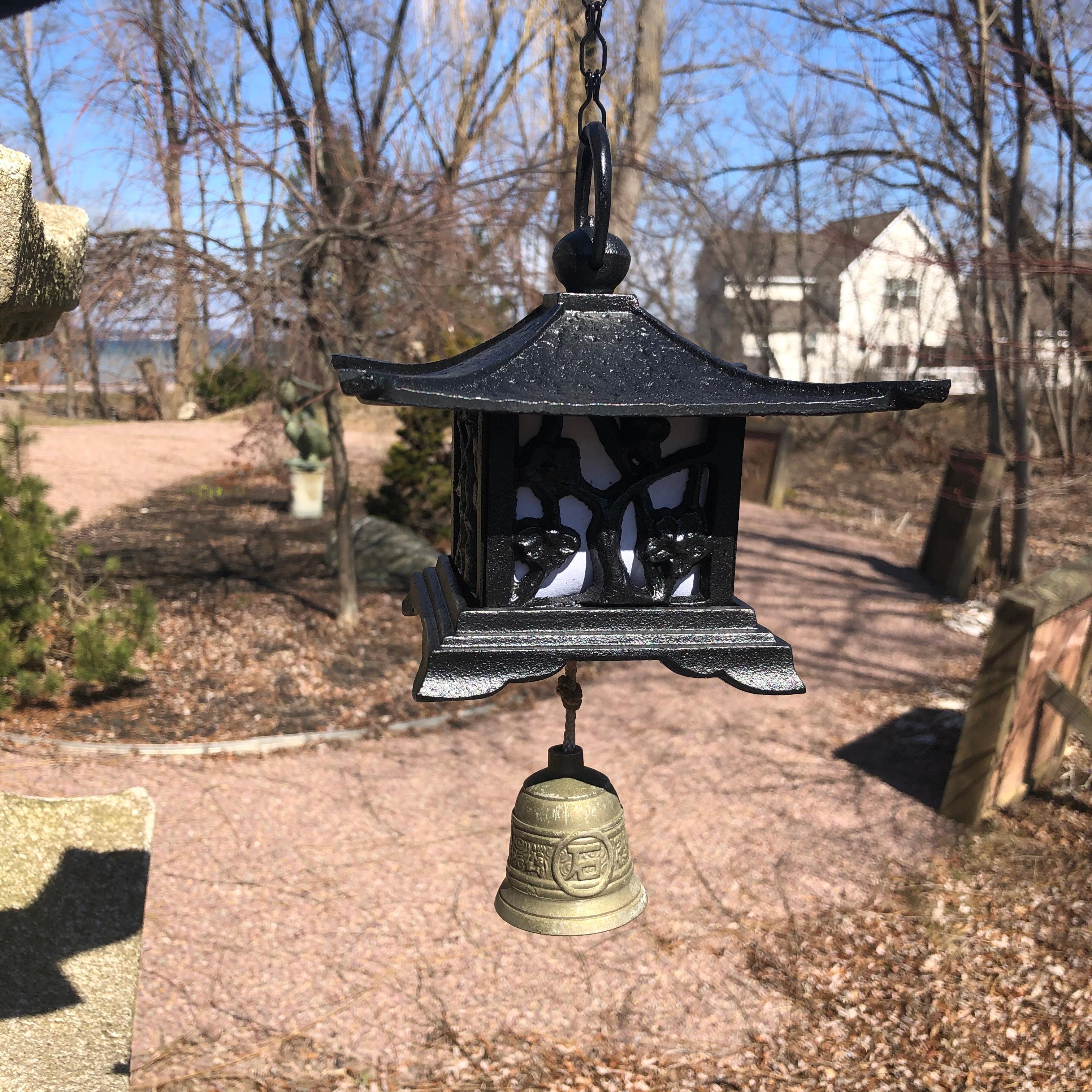 A first of its kind.

Japan, a handsome and unusual hand cast ringing lantern plus wind chime in the form of a Japanese mountain cabin that may be suspended or placed on any surface in your favorite indoor or outdoor space. 

The extra 24 inch