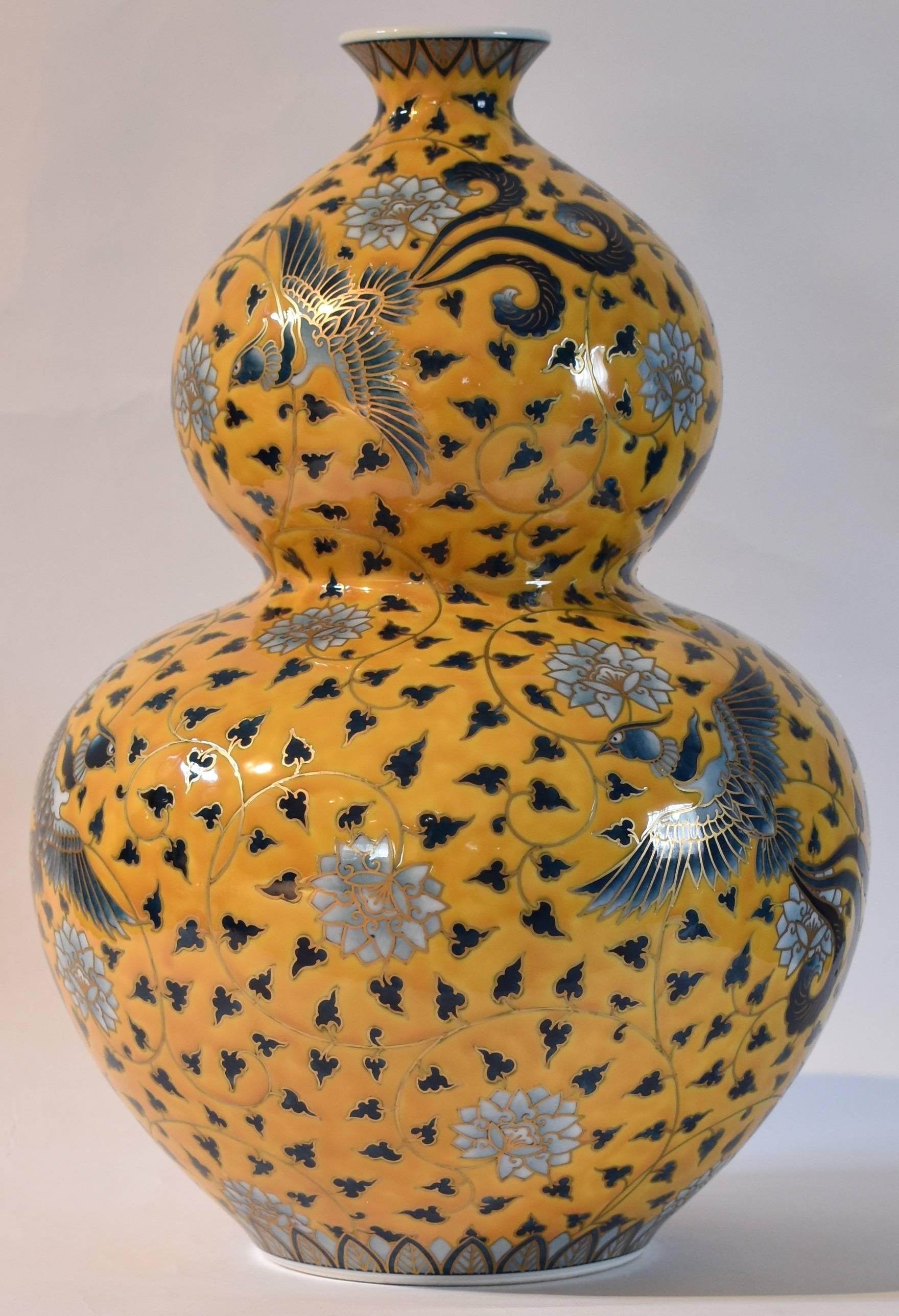 Exceptional large yellow gilded hand painted contemporary Japanese Cerami vase, presented in an auspicious double-gourd form combining an arabesque motif with birds and flowers set against a brilliant yellow background, a masterpiece by highly