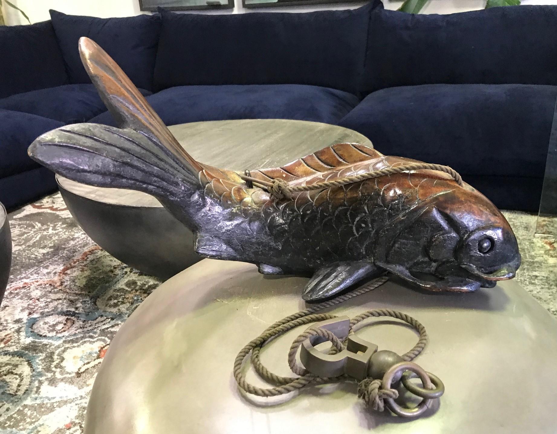 A wonderfully carved old Japanese Koi fish, a symbol of prosperity, perseverance, and good fortune. The sculpture retains its original dark, rich patina. Traditionally, these works were often displayed in Japanese main living rooms, suspended with