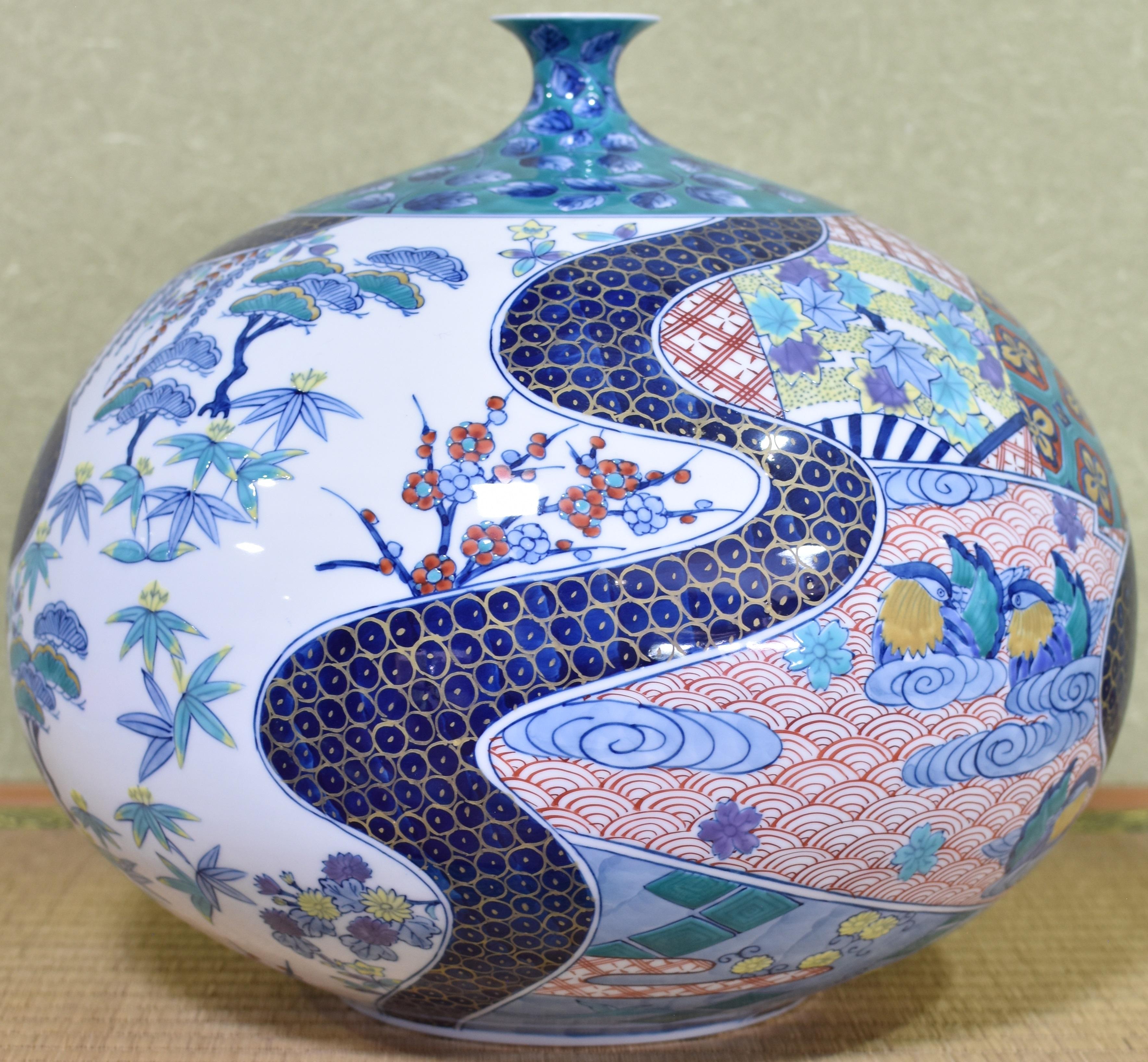 Exceptional Japanese contemporary ovoid decorative vase, hand-painted on a stunningly shaped porcelain body in blue and red, a masterpiece by  highly-acclaimed award-winning master porcelain artist in Japan's Imari-Arita region. It is divided into