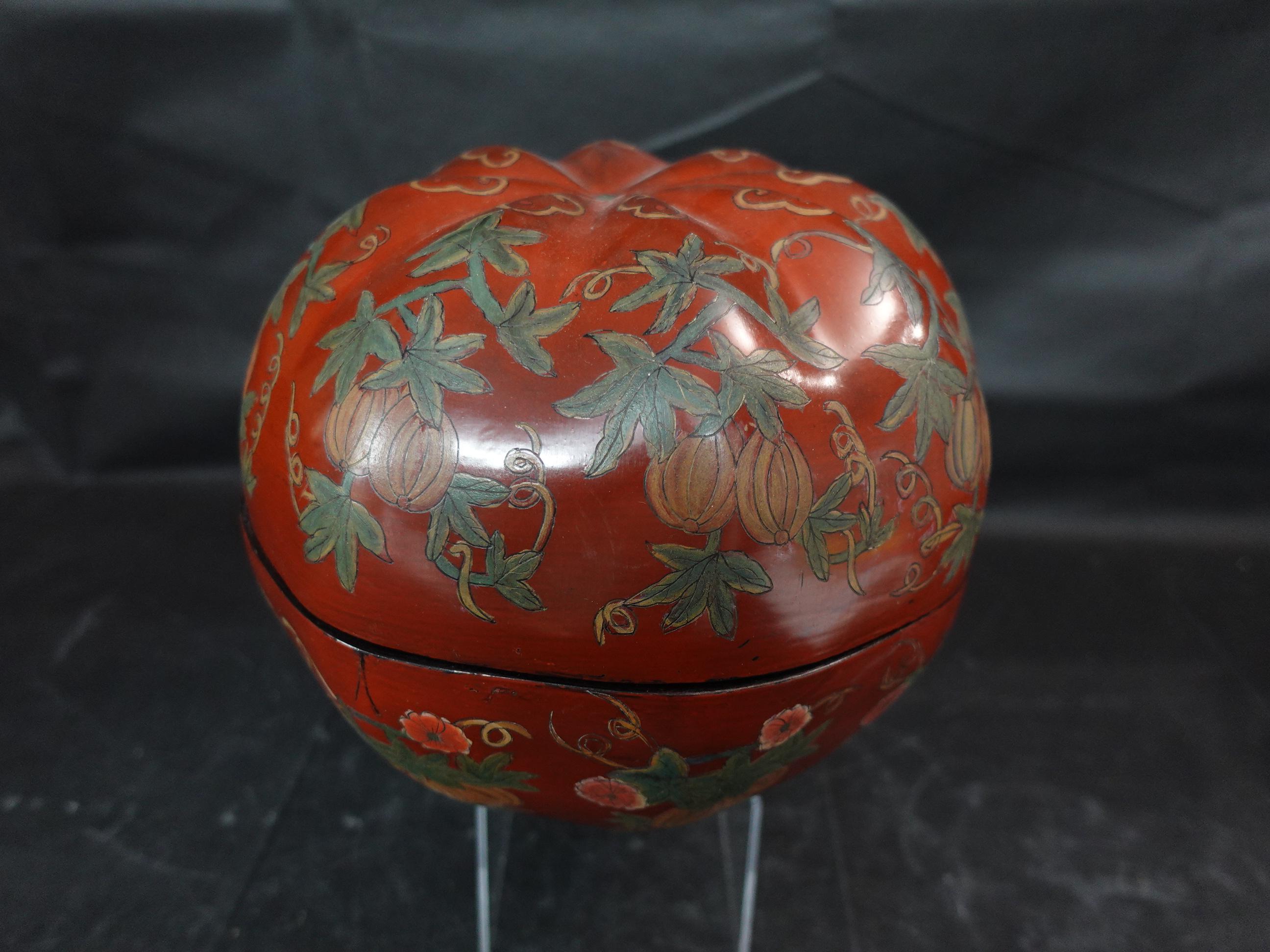 Japanese large lacquer box with a cover in pumpkin shape, depicting the pumpkin with vines, leaves, and flowers.