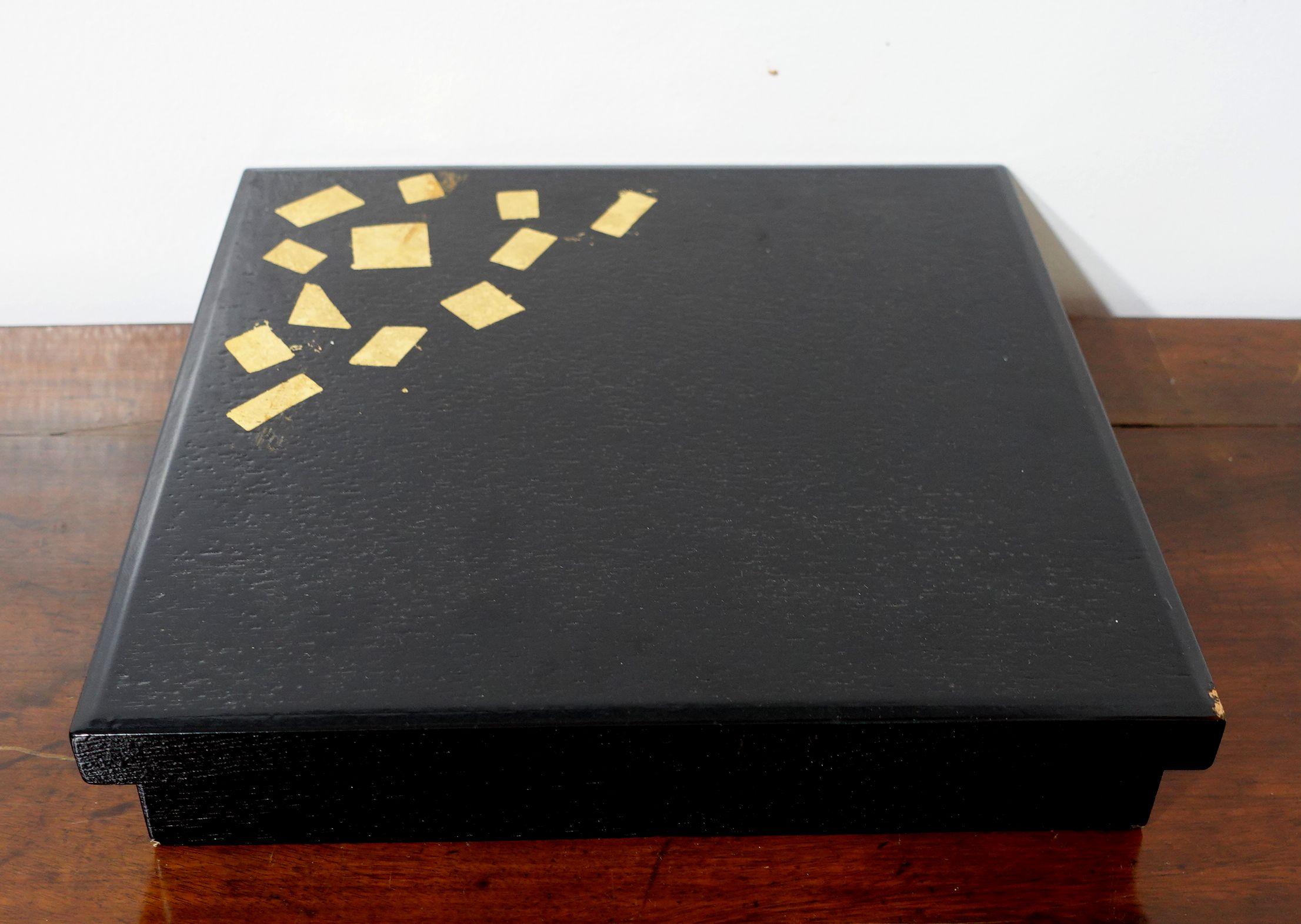 Japan, late Meiji period or later, a large black square organizer box and cover, decorated with geometric squares in gold on the cover