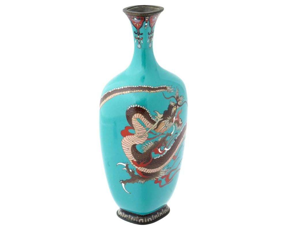 An antique Japanese copper vase with a cloisonne enamel design against a turquoise background. Late Meiji period, before 1912. The vase of an elegant baluster shape with a pronouncedly elongated narrow neck. The body of the vase is decorated with a