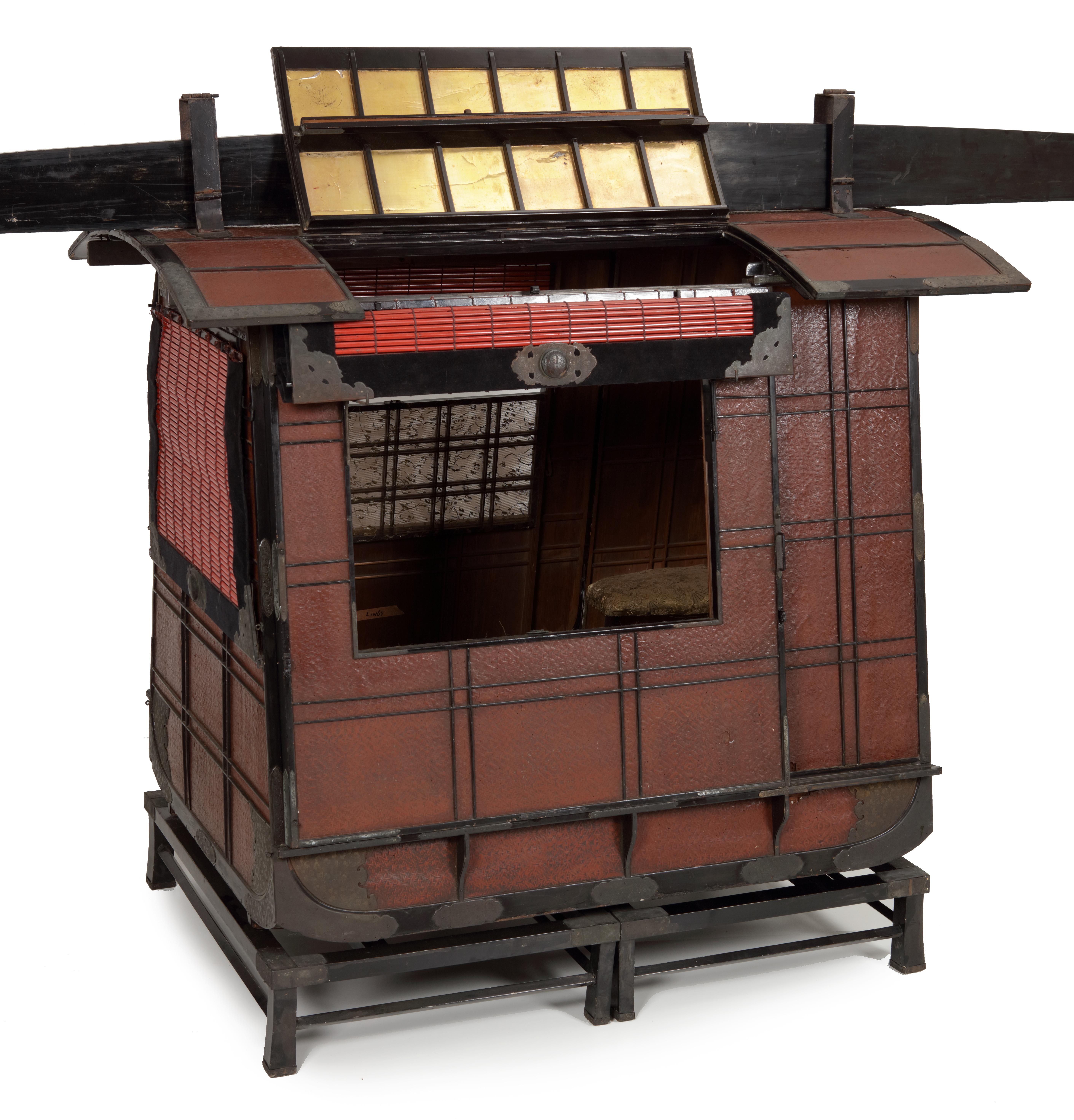 A Japanese red and black lacquered palanquin or norimono

Edo period, early 19th century
 
Made of lacquered wood, latticework and bamboo, black velvet and gauze with gilt scrolling vine decorations, sliding doors and roll-down shutters and