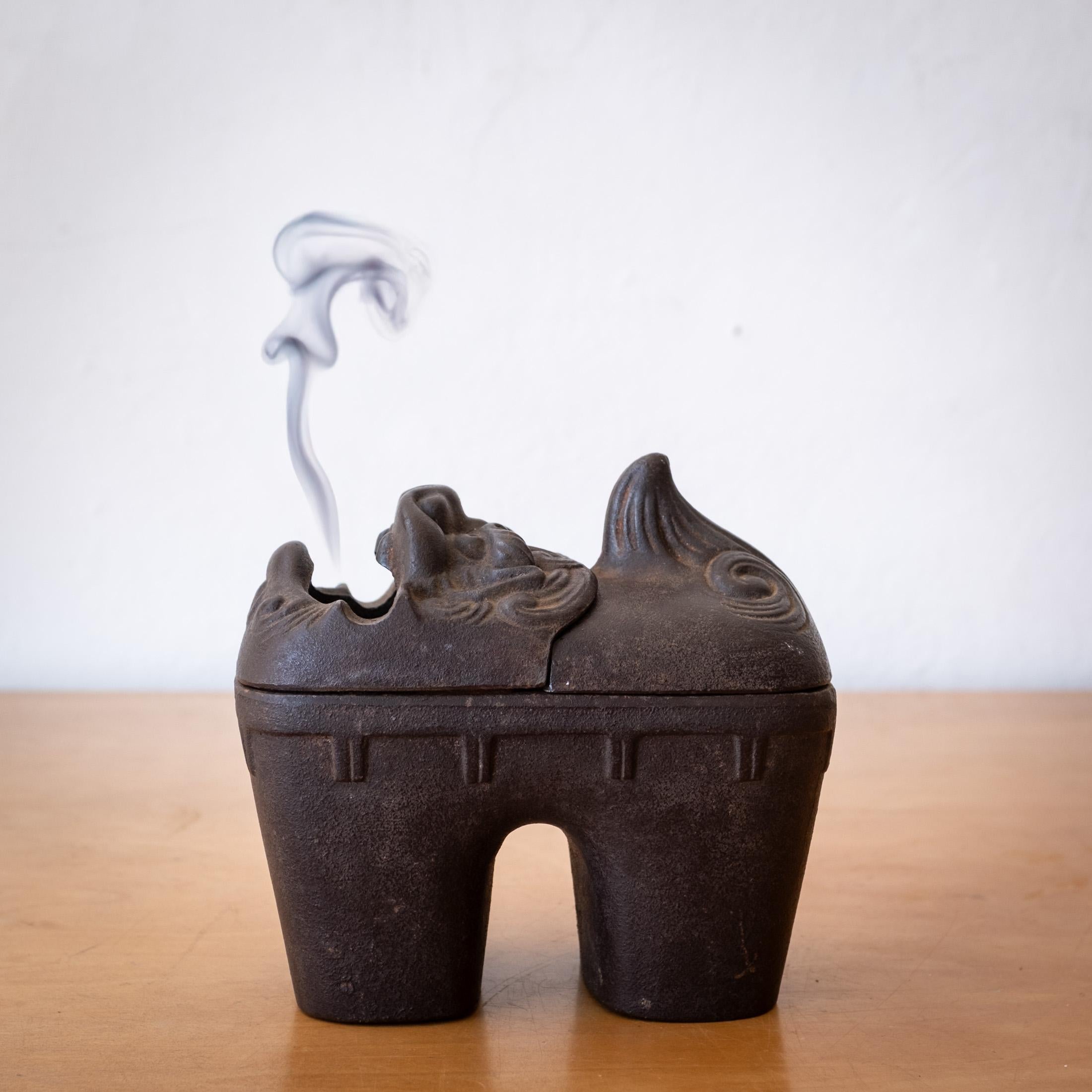 Iron Lion sculptural vessel from Japan. Great form. It could be used as a incense burner or sculpture. Two removeable pieces on the top reveal a divided container.  Wonderful patina. Signed on the bottom. 