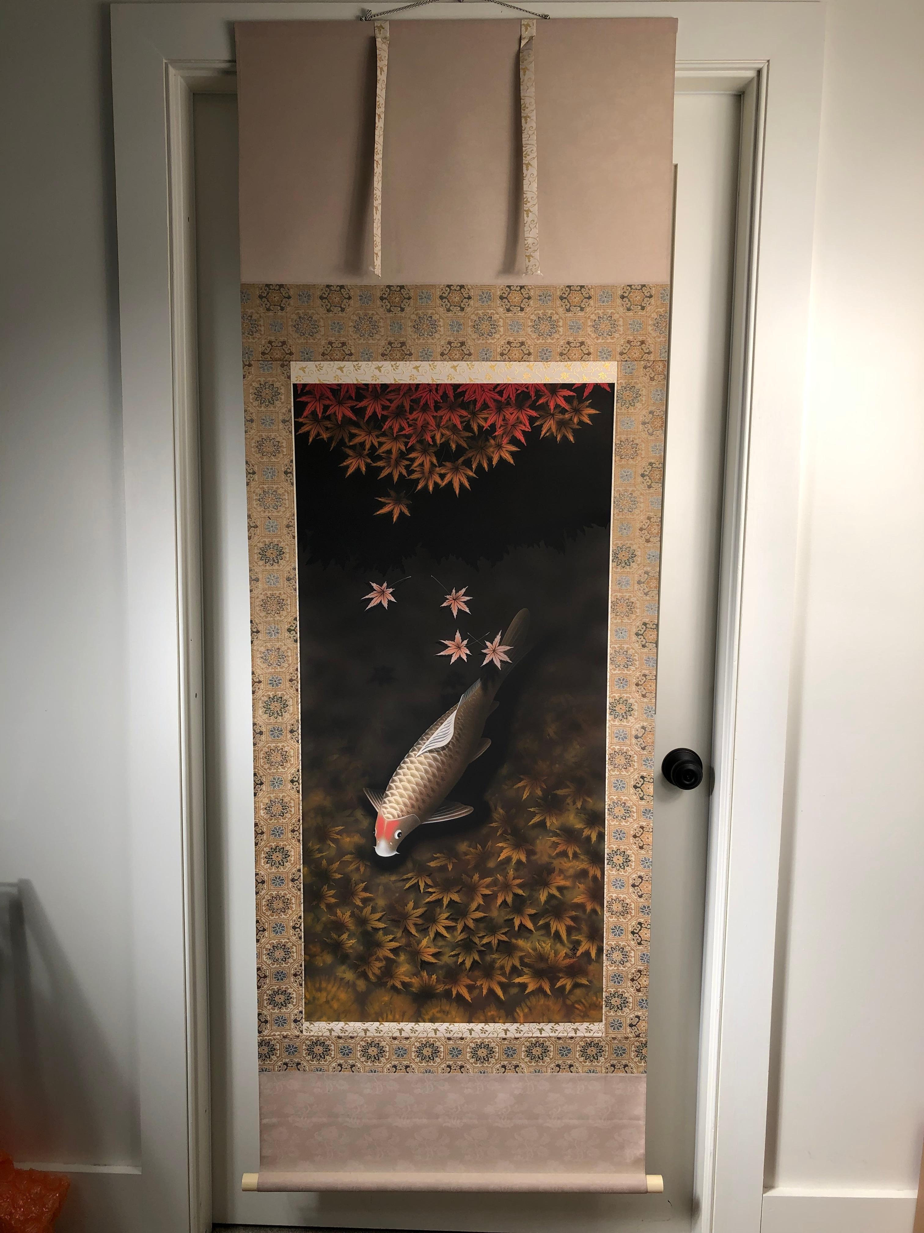 Japan, a stunning large scroll painting of Koi lazily swimming in a placid pond among Momiji fallen leaves. Hand painted in vibrant colors- an auspicious art composition rendered on silk scroll dating to the middle Showa period. And signed