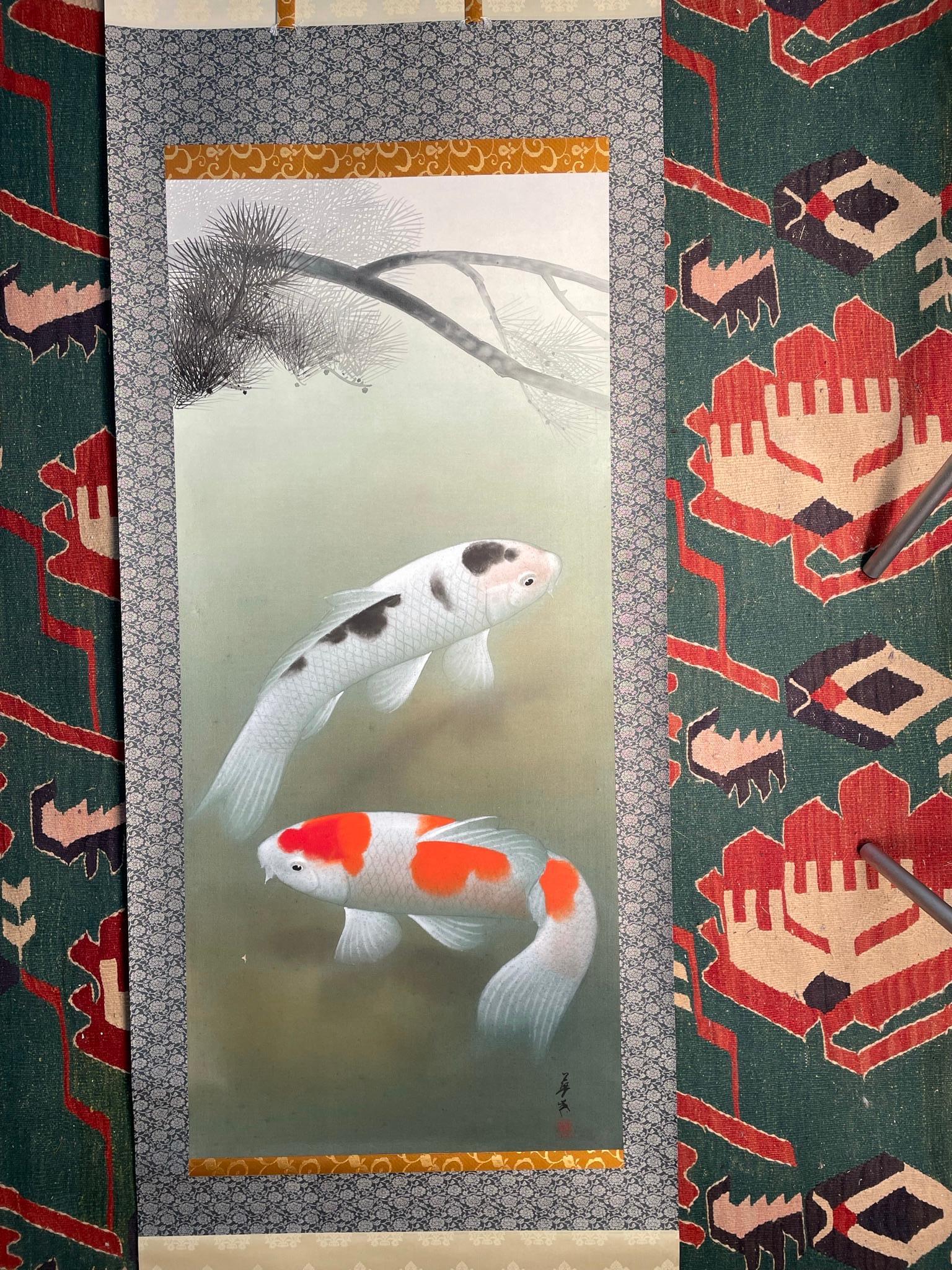 Japan, a stunning large scroll painting of Koi lazily swimming in a placid pond among Momiji fallen leaves. Hand painted in vibrant colors- an auspicious art composition rendered on silk scroll dating to the middle Showa period. And signed