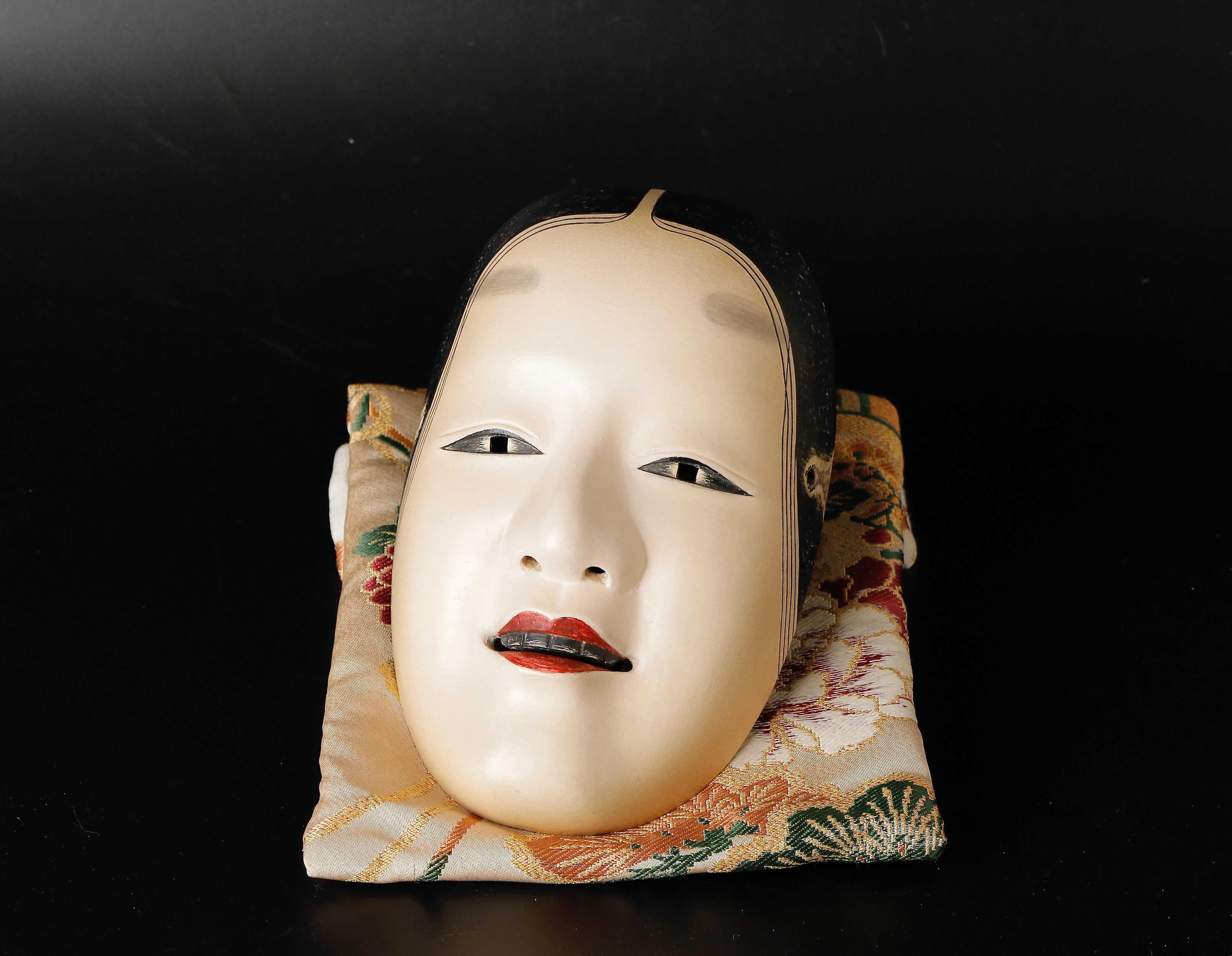 This exceptional Japanese Magojiro Noh mask is skillfully crafted using traditional techniques, and represents a calm and benevolent woman. The mask was created by the highly talented artist, Watanabe Shuji.

The Magojiro Noh Mask is a distinctive