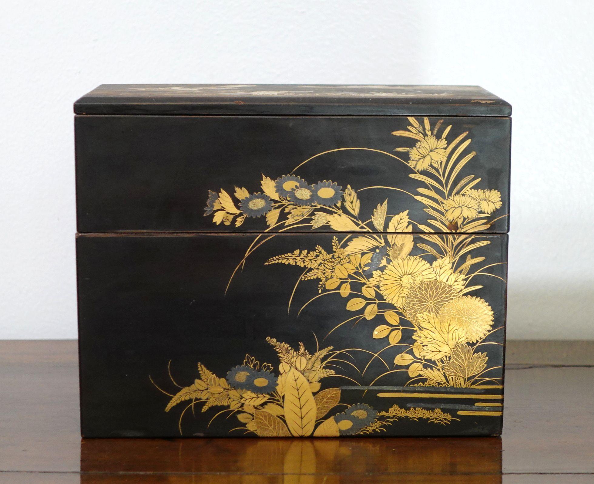 Japan, Edo to Meiji period, two-tiered, with the cover with a landscape design, the four sides with guilt chrysanthemum flowers.