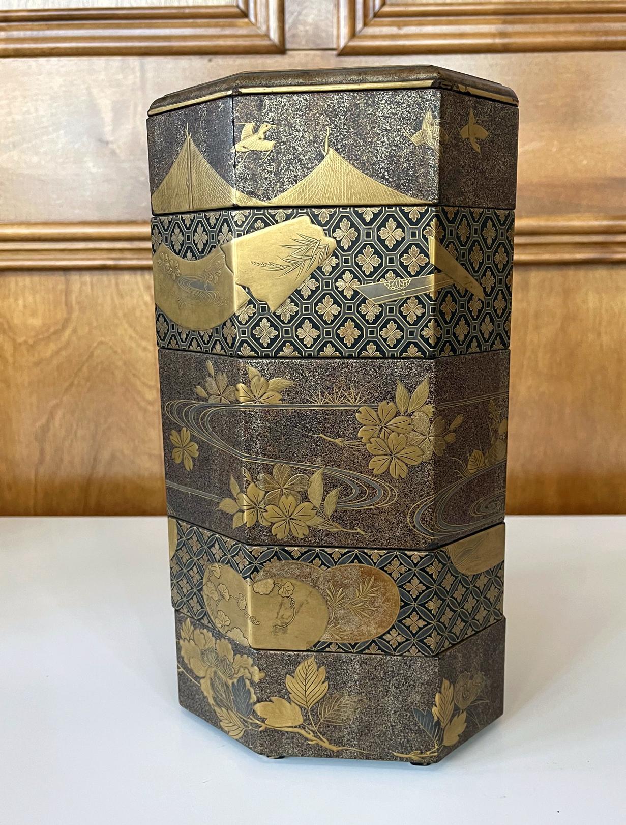 An antique jubako (stack boxes) with five tiers in an elongated octagon shape circa 19th century (end of Edo or beginning of Meiji period). jubako was traditionally used to store and carry foods in Edo time, often as part of the accoutrement with a