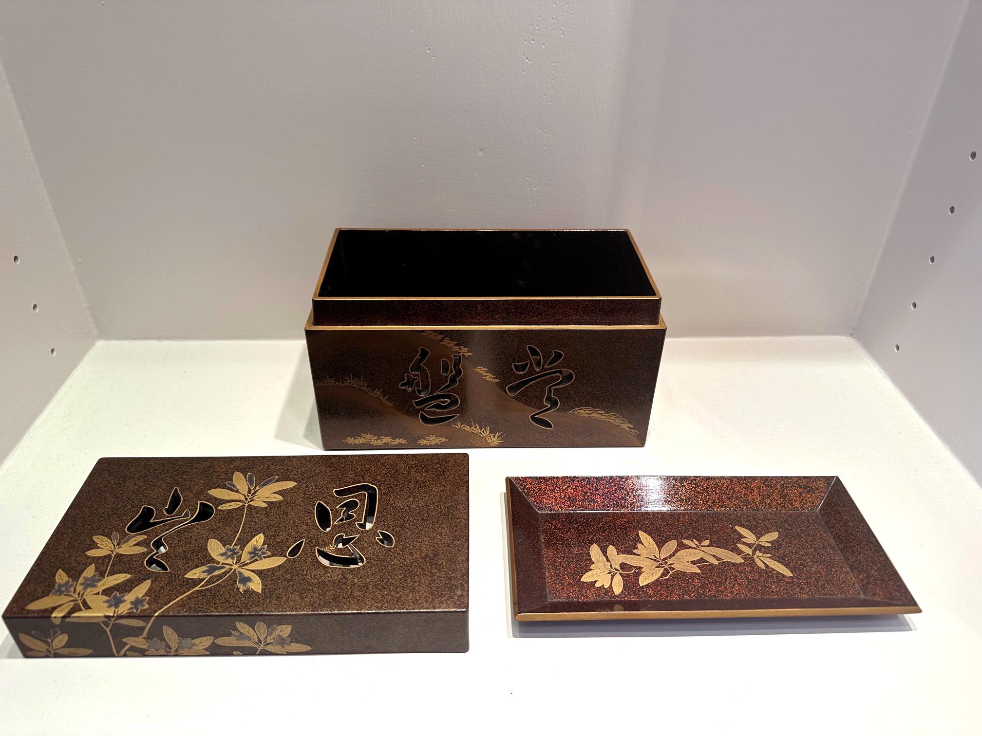 A Japanese lacquer box with lid and an inner tray decorated with Maki-e on a dense nashiji background. The fine box was likely made circa 1920-30s during the Tashio period and likely used for tea ceremony. The low relief hiramaki-e depicts a gentle