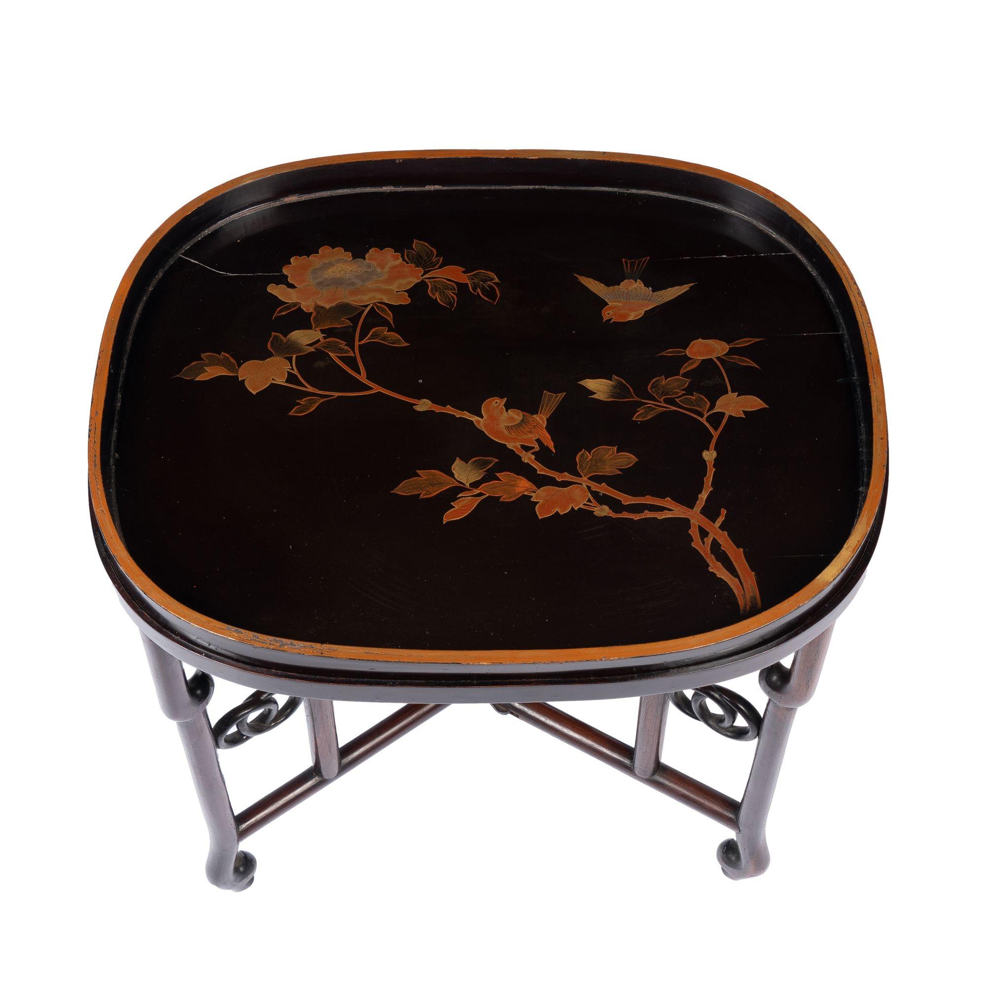 Japanese standing rim, Maki-e lacquered oval wood tray of the Meiji Period. The tray features fine gilt decoration in the form of two small birds, possibly sparrows, fluttering among peony branches. The tray is fitted to a custom rim on a Chinese