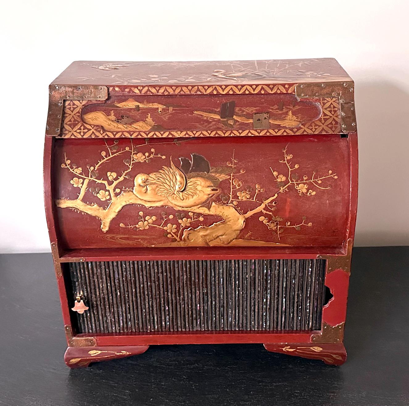 An antique Japanese Kodansu with two compartments and multiple drawers with red lacquer finish and gold Maki-e and wonderful Raden shell inlays decoration. This rather unusual piece was likely made on Ryukyu Islands circa late 19th century as a