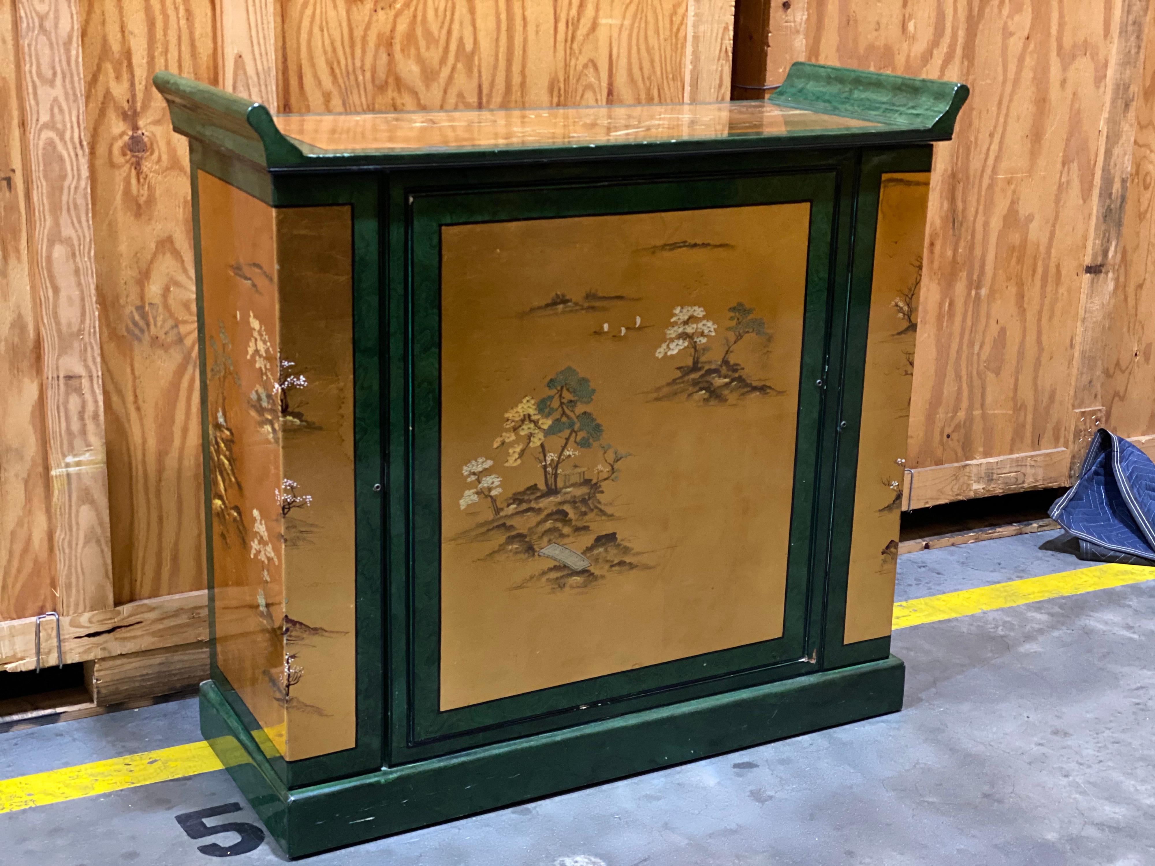 Japanese Malachite Green & Gilded Chinoiserie Faux painted bar cabinet
A fabulous looking piece with a very useful inside!
Center section rotates 360 degrees and has place for a full bar.
Right section has holders for 18 glasses
Left section has