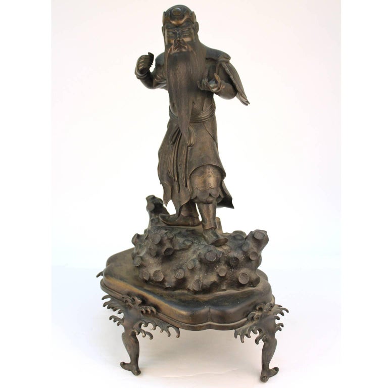 A Japanese Meiji-era finely cast bronze sculpture of a mythical guardian of the sea. Excellent condition with original patina and finely cast textures. Missing a staff or weapon. No signature or markings.