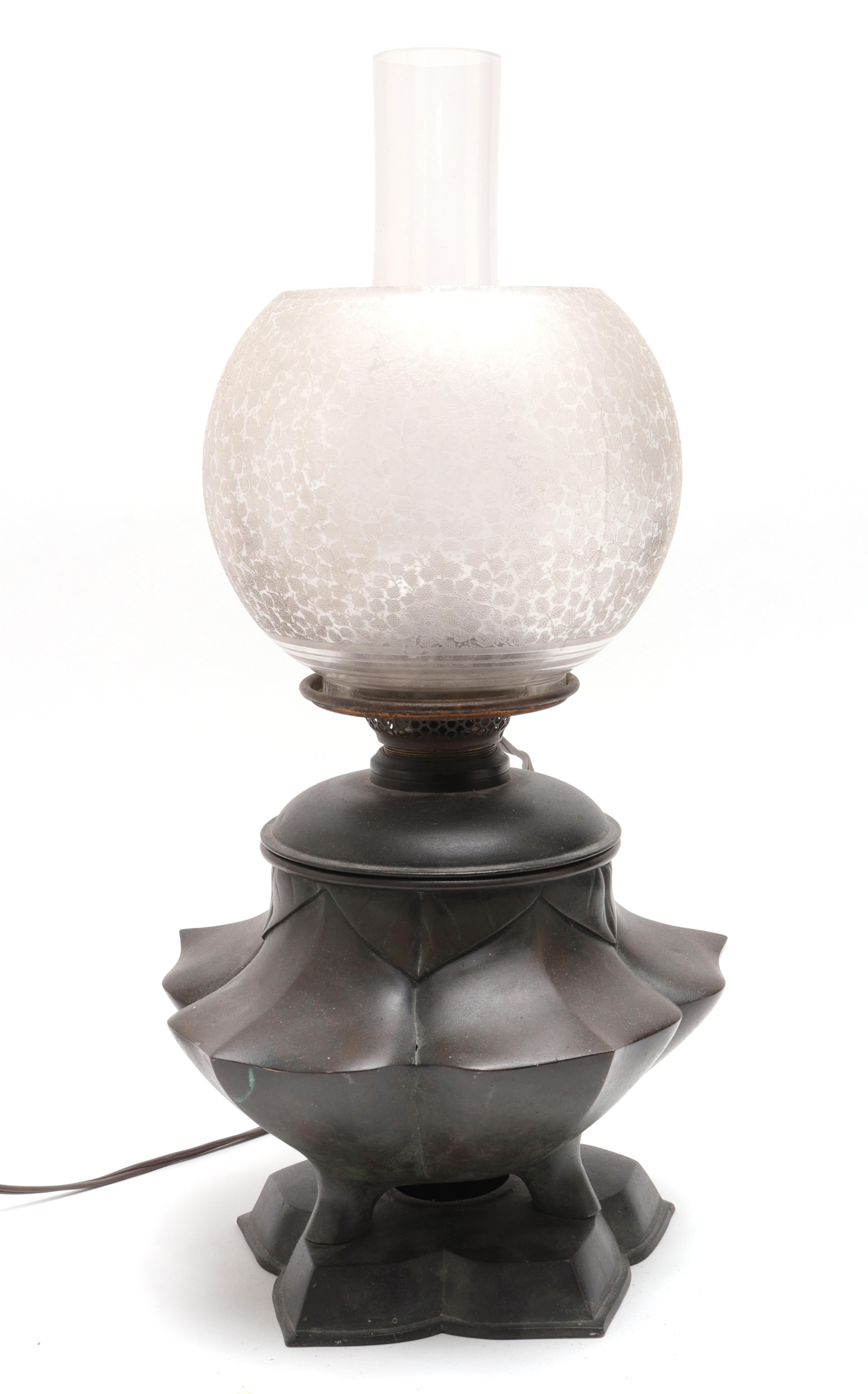 Japanese Meiji period electrified oil table lamp with lotus shaped base and original glass shades. The piece is in great antique condition with age-appropriate wear and use and a desirable patina on the bronze.