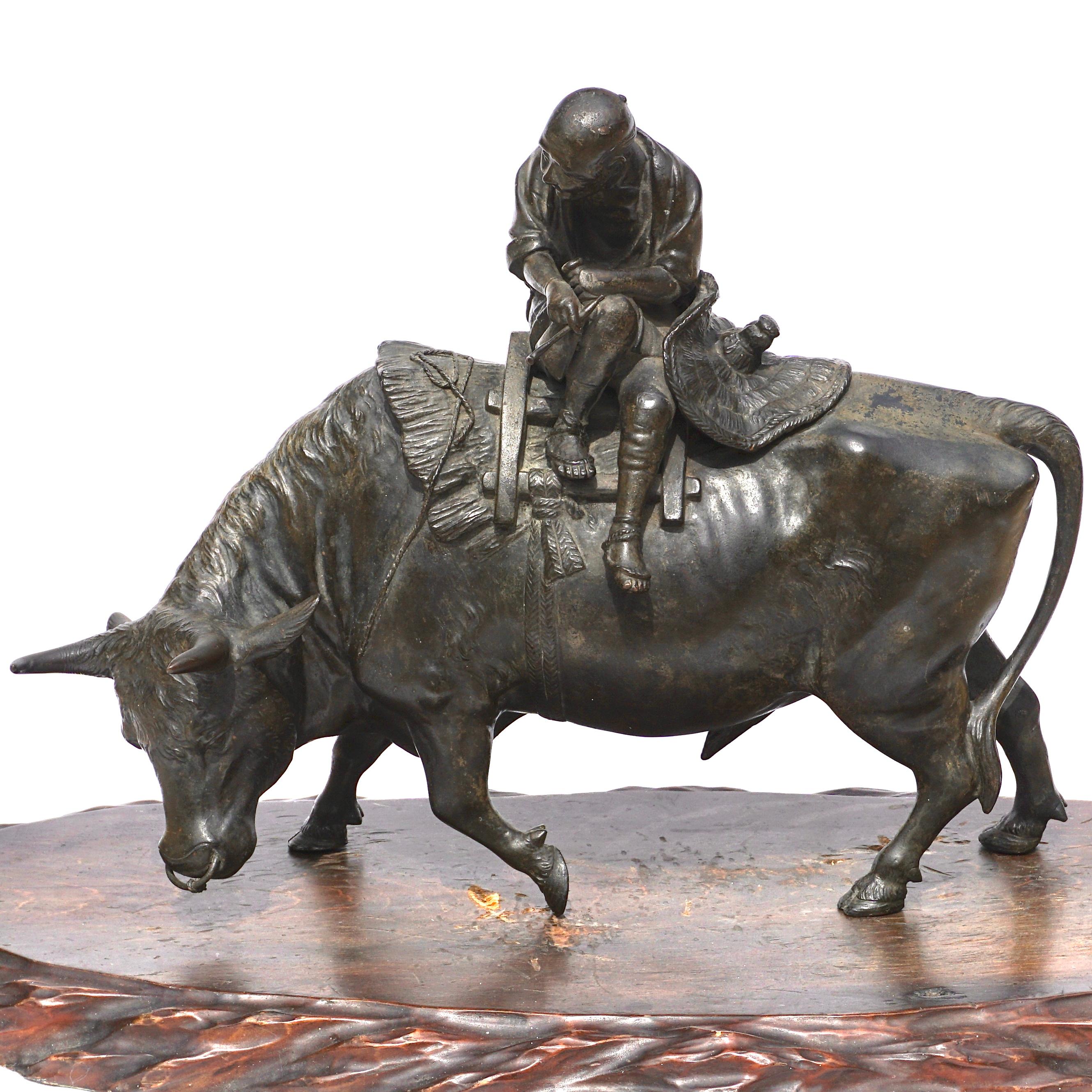 A very large 19th century fine Japanese bronze depicting an old man with a pipe sitting of a Ox or water buffalo. The figures show movement and character with historical and cultural significance, circa 1890.

Signed near penis.

Measures: Height