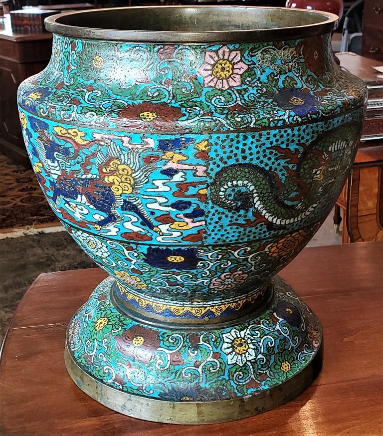 Presenting a gorgeous Japanese Meiji Champleve and bronze urn.

Made in Japan during the Meiji Period circa 1880.

The body of the urn is cast bronze and it is entirtely covered in various colored enamels in the manner of Champleve, depicting