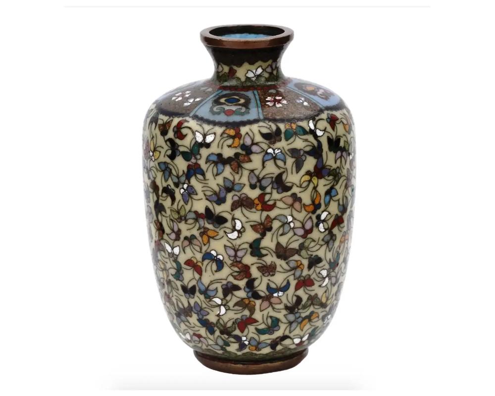 An antique Japanese copper vase with cloisonne enamel design. Late Meiji period
. Rounded vase with pronounced neck. The body is covered with a butterfly pattern, the neck is decorated with geometrical ornaments. Collectible Oriental Decor For