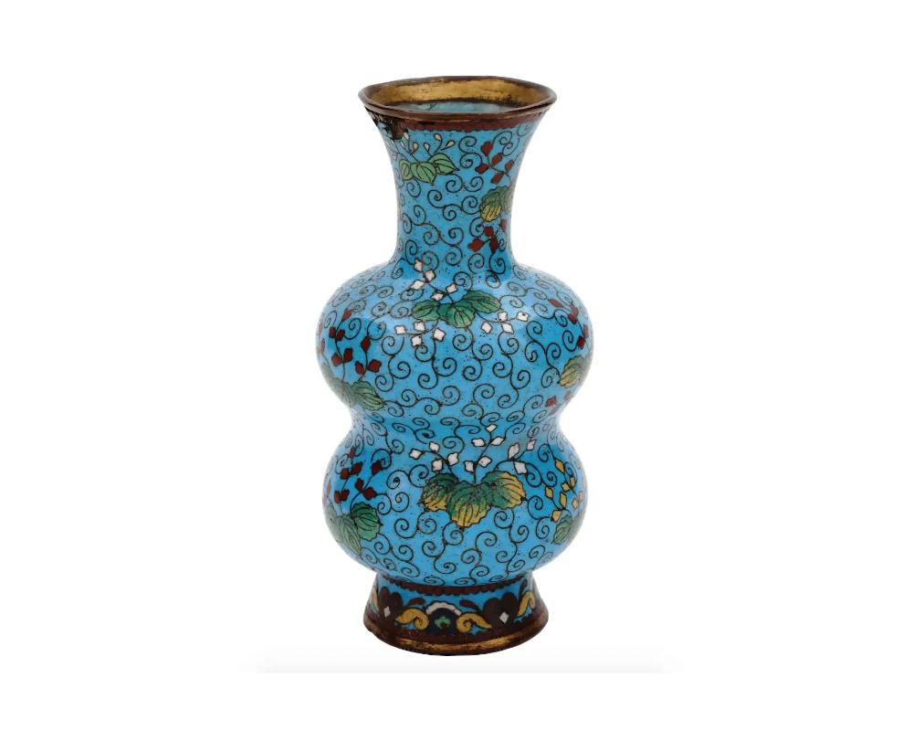 An antique Japanese copper vase with cloisonne enamel design. Meiji period

Double-gourd shape with pronounced base and neck.

Turquoise body with floral ornaments.

Collectible Antiques Oriental Home Decor Items.

Dimensions: H 4 in. All