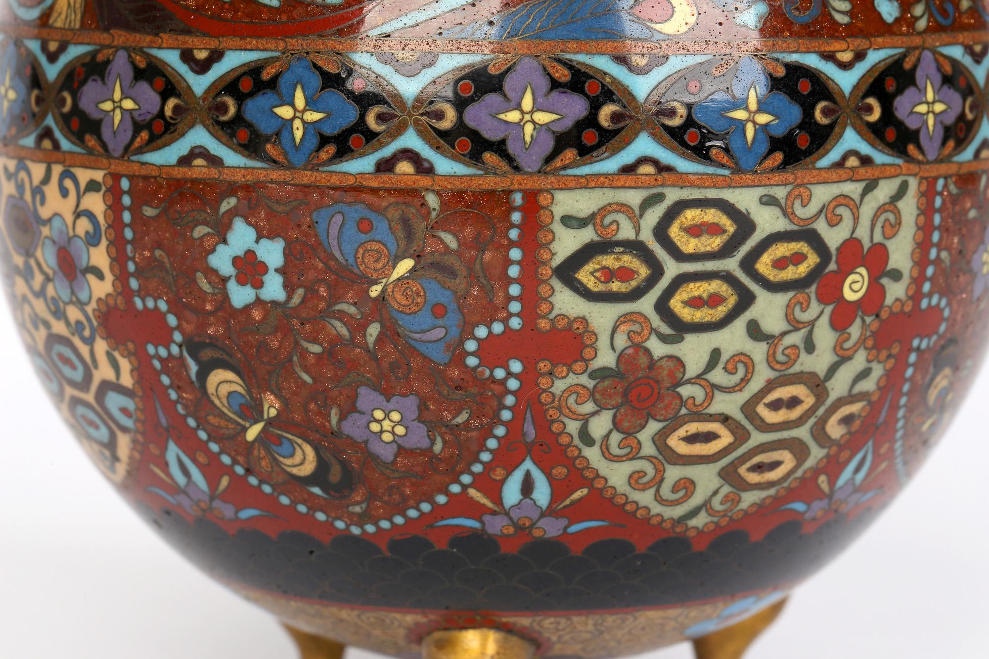 Japanese Meiji cloisonné tea caddy exquisitely decorated with Ho Ho birds above decorative shield shaped panels probably dating from around 1870. The tea caddy is of rounded shape standing raised on three shaped small brass feet and with a recessed