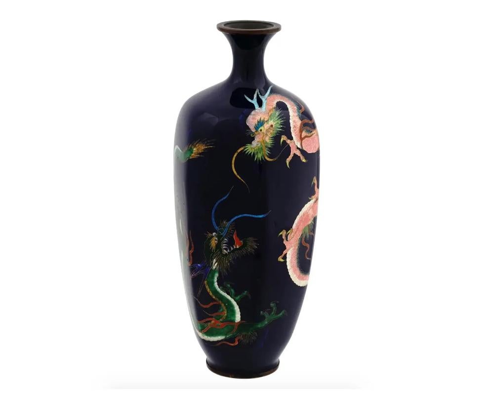 An antique Japanese copper vase with cloisonne enamel design. Late Meiji period,

Faceted elongated vase with pronounced neck. Cobalt blue body is decorated with depictions of two dragons.

Unsided but attributed to KUMENO TEITARO for similar