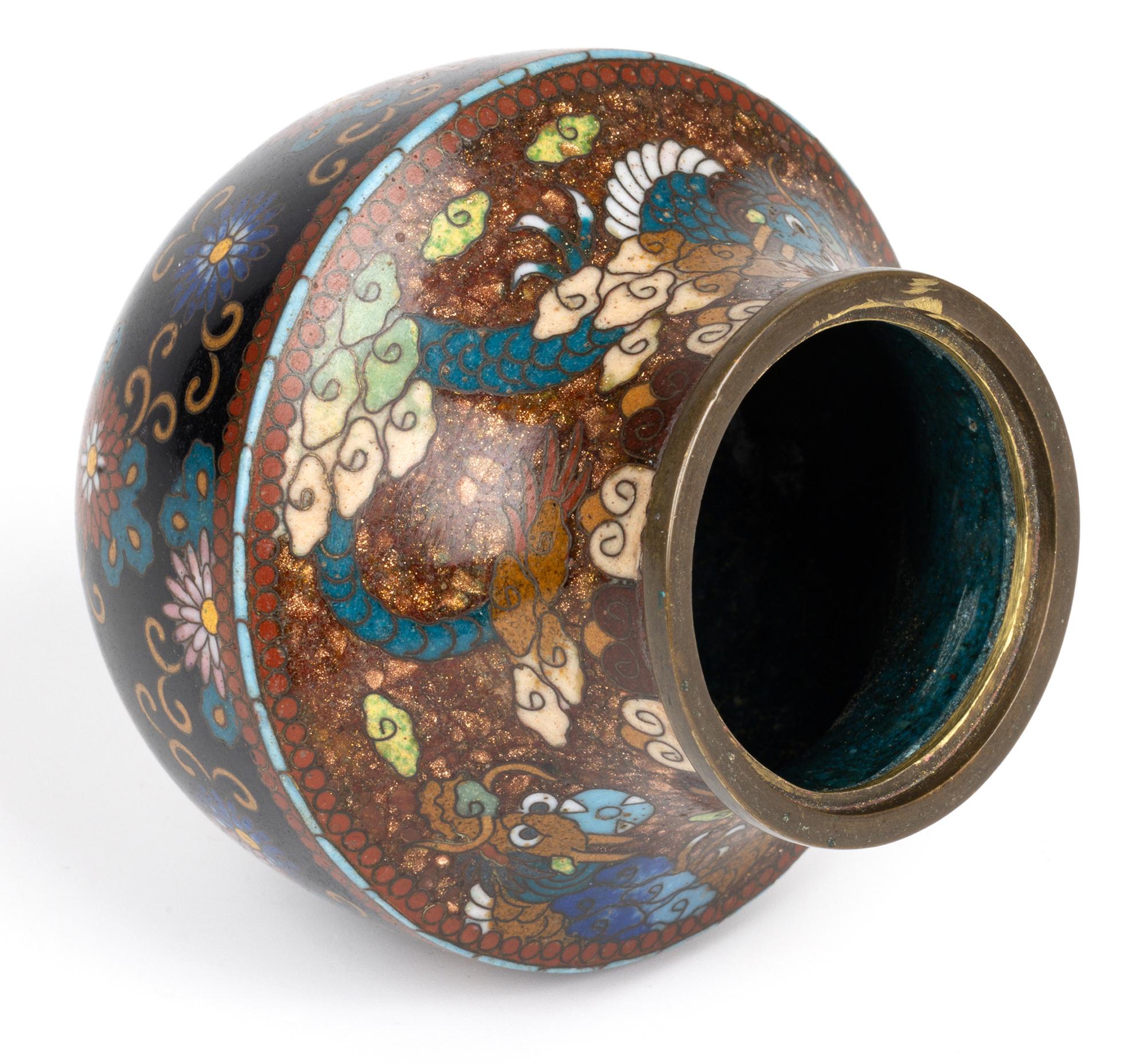 A stylish antique Meiji period Japanese cloisonne Koro and cover decorated with dragon and floral designs and dating from around 1880. This delightful Koro stands raised on three brass feet supporting a rounded bowl-shaped body with a tapering