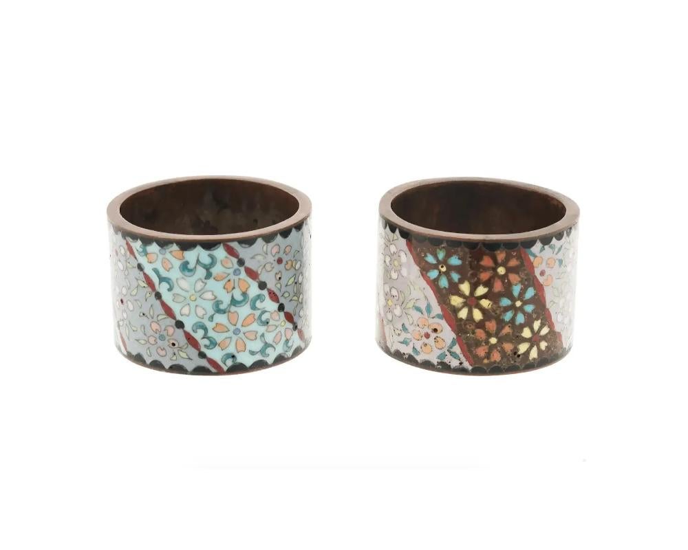 A pair of antique Japanese Meiji Era copper and enamel napkin rings. Circa: early 20th century. The wares are enameled with polychrome floral and foliage patterns made in the Cloisonne technique. Unmarked. Antique and Vintage Asian and Oriental