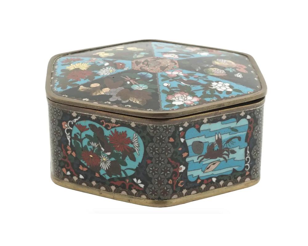 Large Meiji Japanese Cloisonne Enamel Box with Fruits, Sea Life, Birds and Insects Coffee Table box
An antique Japanese copper trinket box of hexagonal shape with cloisonne enamel design.

Late Meiji period,

The piece is decorated with depictions