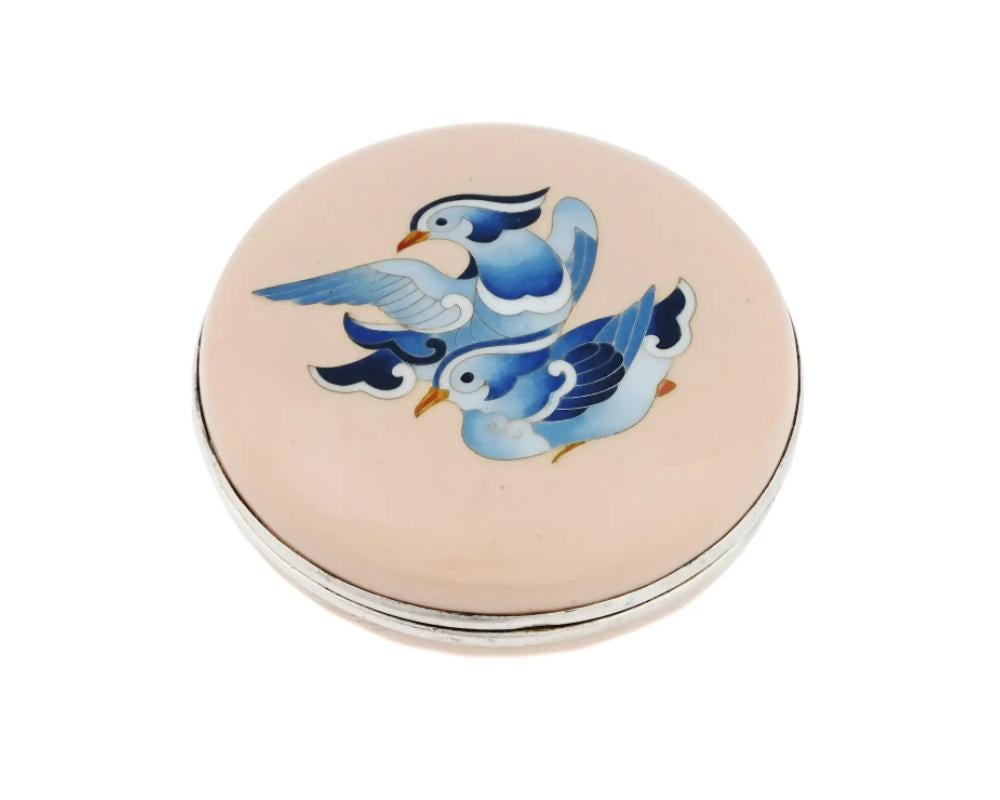 An antique Japanese round cloisonne enameled silver trinket box with screw-on lid. Late Meiji period,
The lid is garnished with a depiction of two blue birds against the pink background.

High quality. Hieroglyphical hallmark Ando is on the