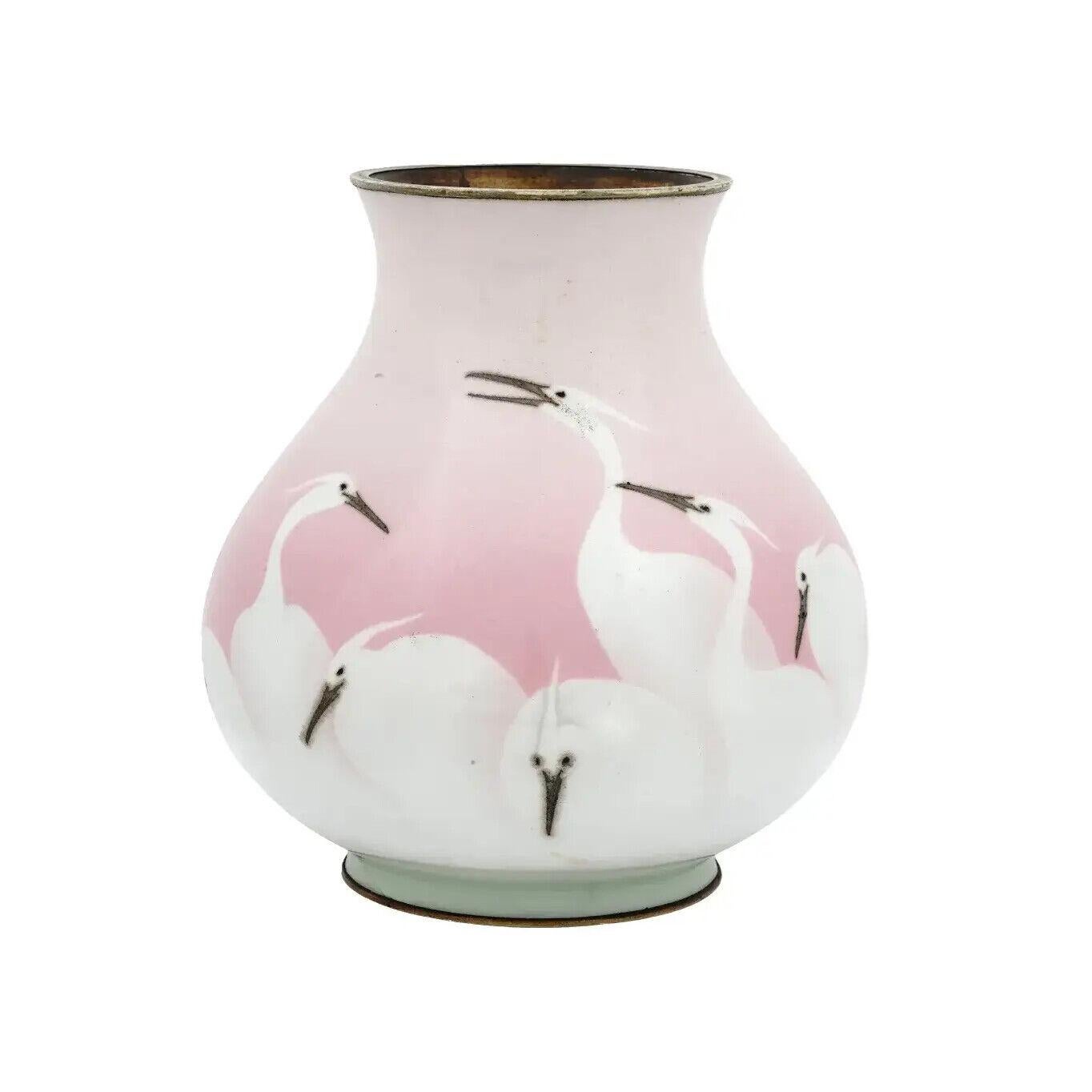 An antique Japanese copper vase with wireless cloisonne enamel design. Late Meiji era, before 1912. Round shape with pronounced base. The piece is decorated with a stork or crane bird motif against the pink background. Collectible Oriental Art And
