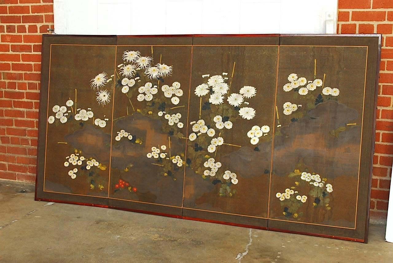 Dramatic early 20th century Japanese late Meiji period Byobu screen featuring painted chrysanthemums. Made in a rare moriage design with raised white flowers for a beautiful 3D effect making them stand out from the painting. Contrasted by a dark