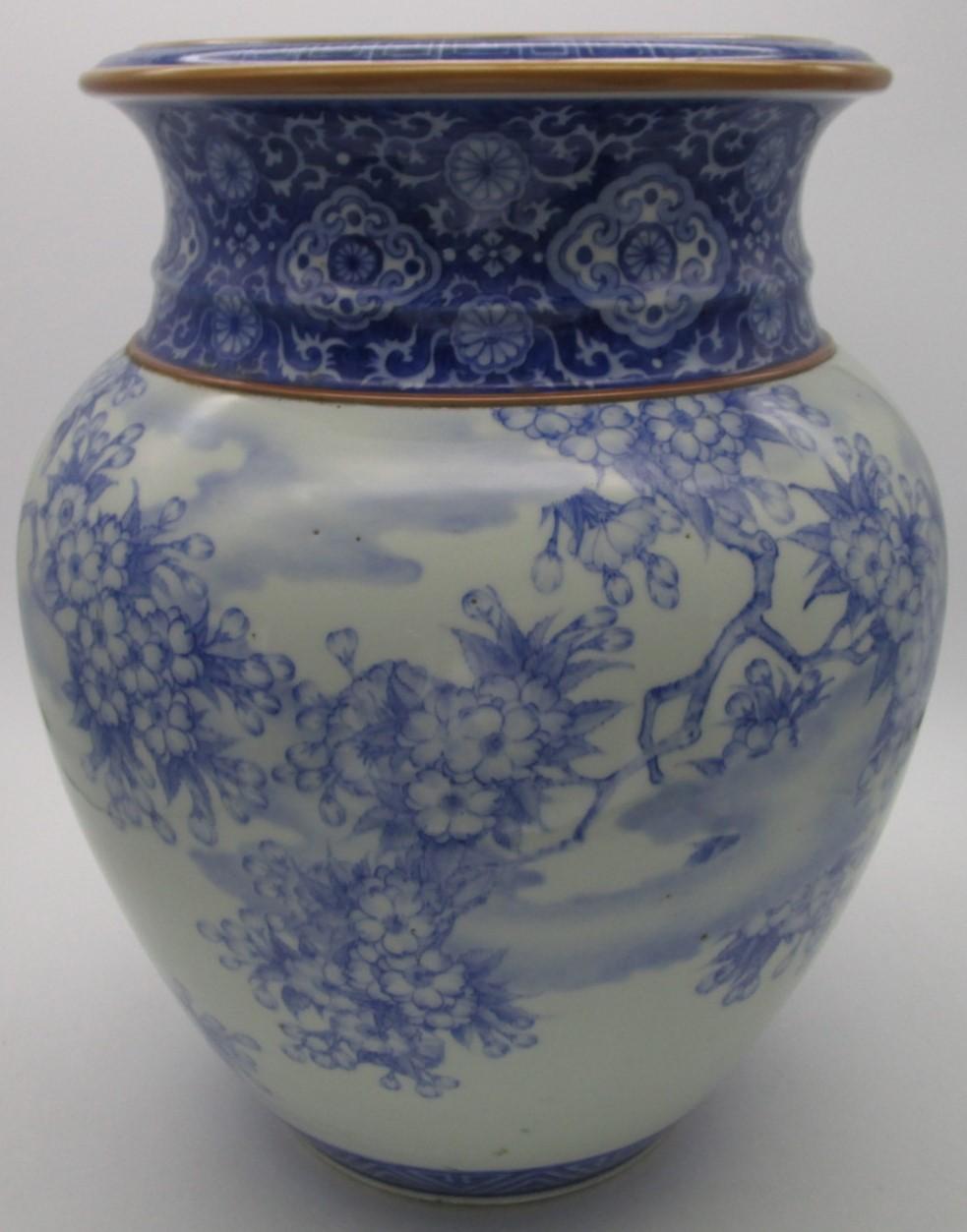 Japanese late-19th century Fukagawa porcelain vase in blue underglaze from Meiji period, (1868-1912,) in a stunning shape depicting intricate cherry blossoms decorating the body pleasantly contrasted by intricate and detailed geometric patterns